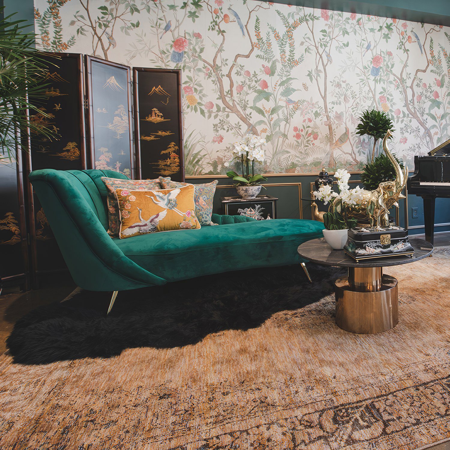 Emerald green velvet chaise with sculpted backrest and gold-tipped legs, available for rent for events in Los Angeles