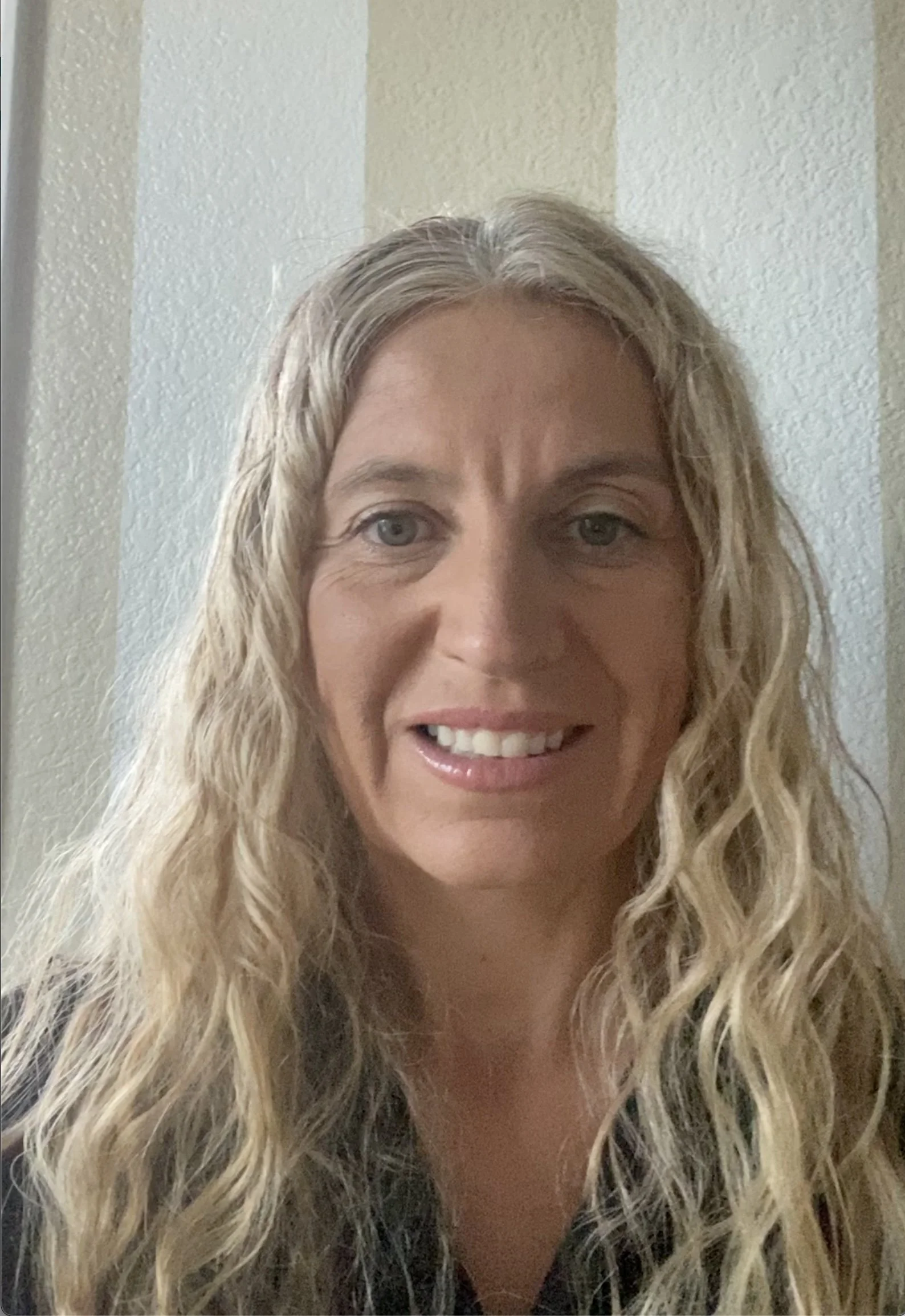 Blonde smiling psychologist with curly hair