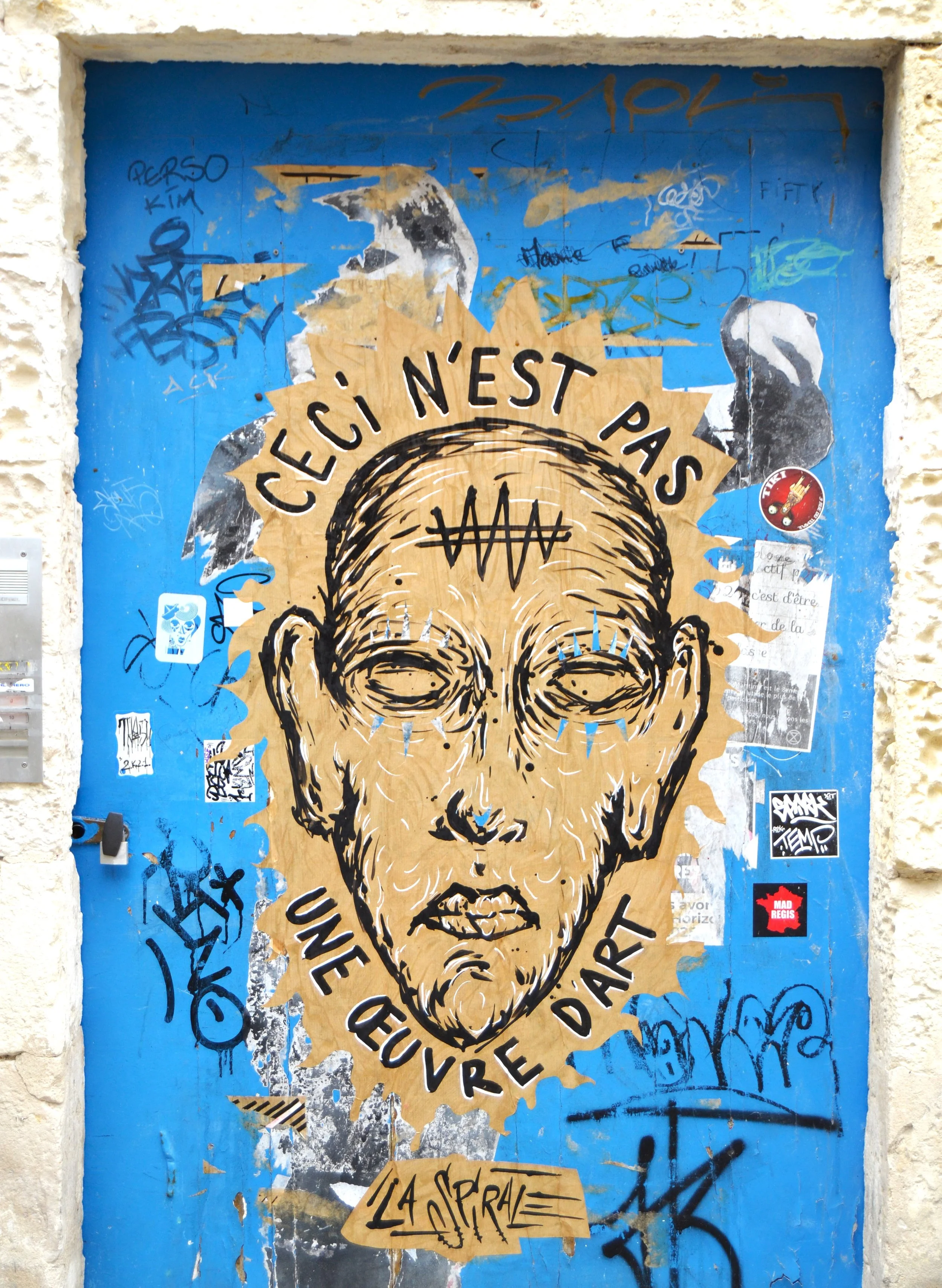 A door painted with a graffitti in Brussels, Belgium.