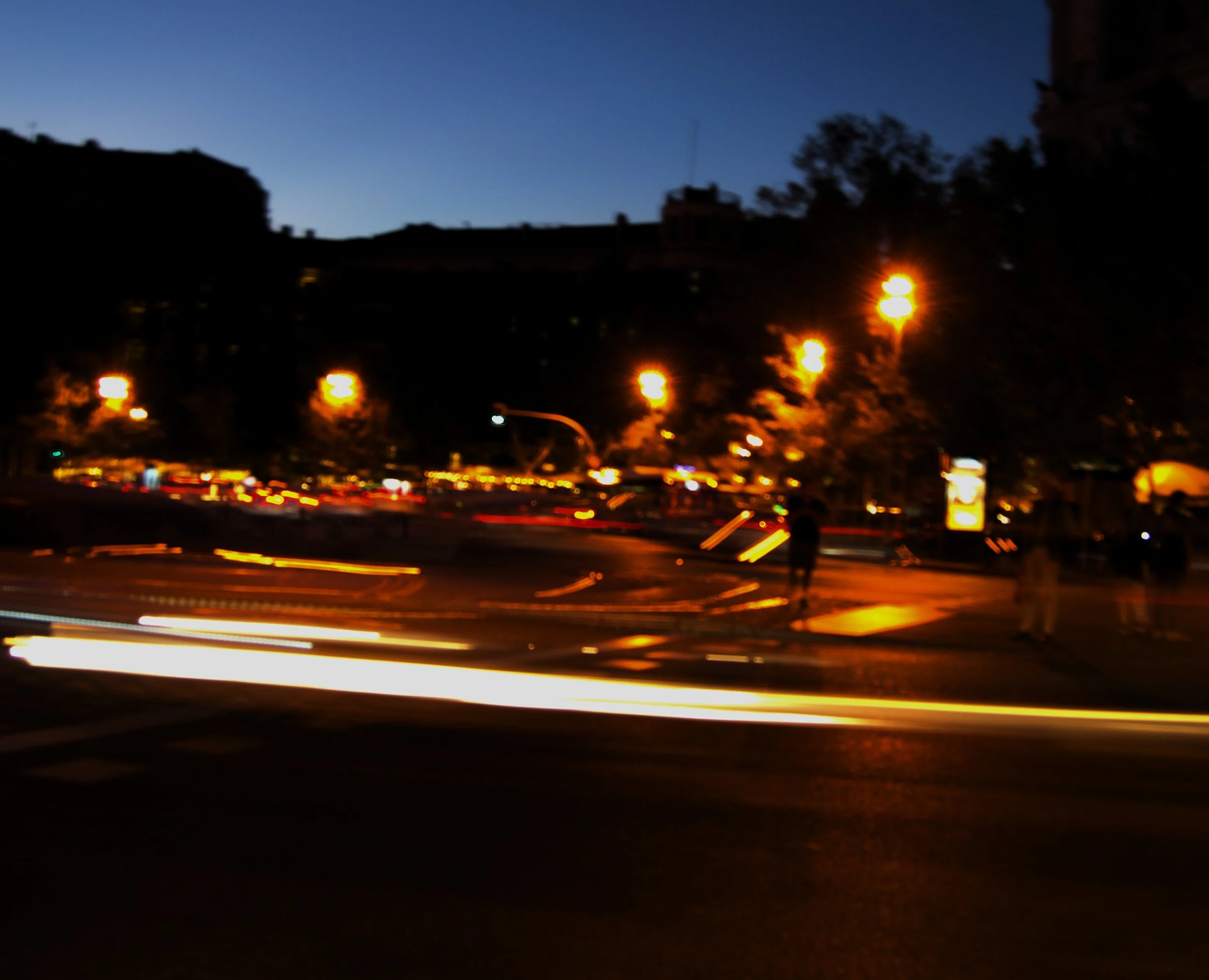 Madrid at night. A walk around the El Retiro Park. Street and cars lights decorating the scene.