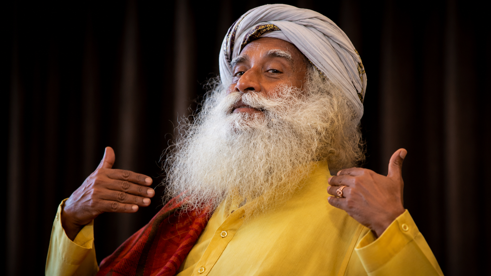 Sadhguru with a proud expression during a public appearance, illustrating the rise of the controversial digital guru and his global influence.