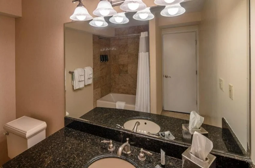 A bathroom with a private hot tub in Collegian Hotel & Suites, Trademark Collection by Wyndham, Syracuse, NY