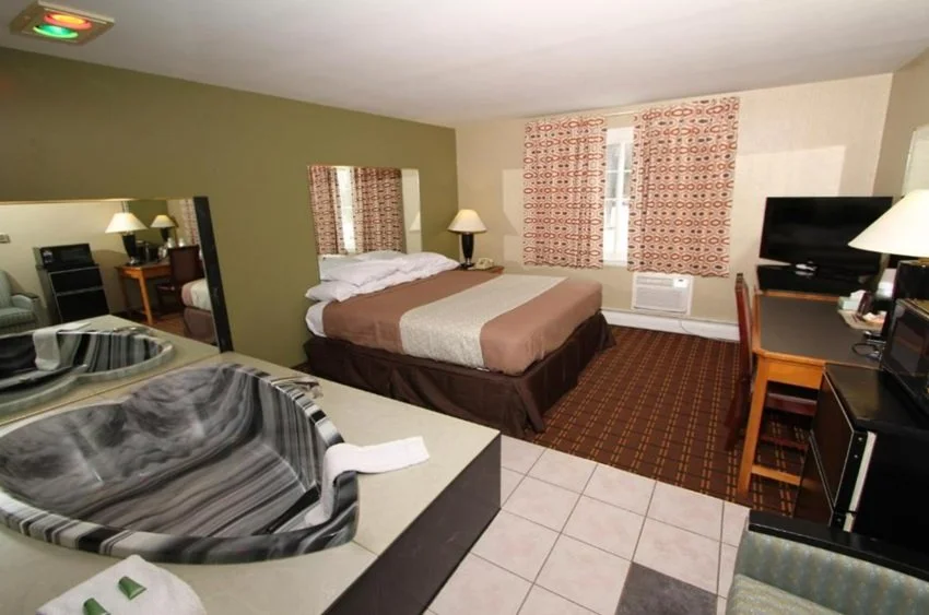 Romantic suite with a heart-shaped hot tub in the room in Budget Inn Cicero, NY