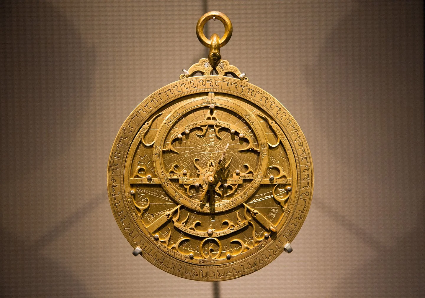 Ancient brass astrolabe artifact with intricate engravings.