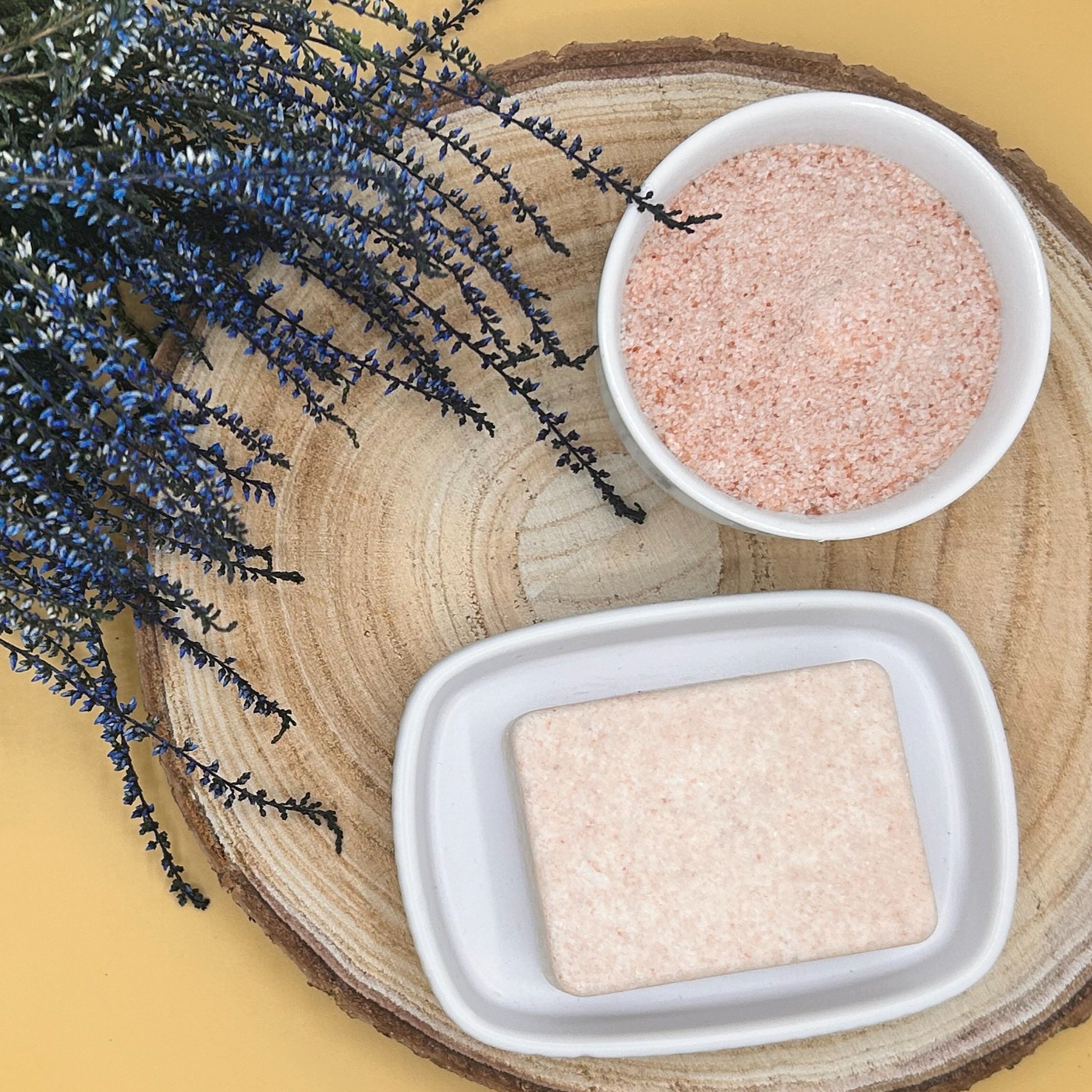 Lavender, Cedarwood and French Pink Clay - Himalayan Pink Salt Soap on a slice of wood and a bowl of salt.