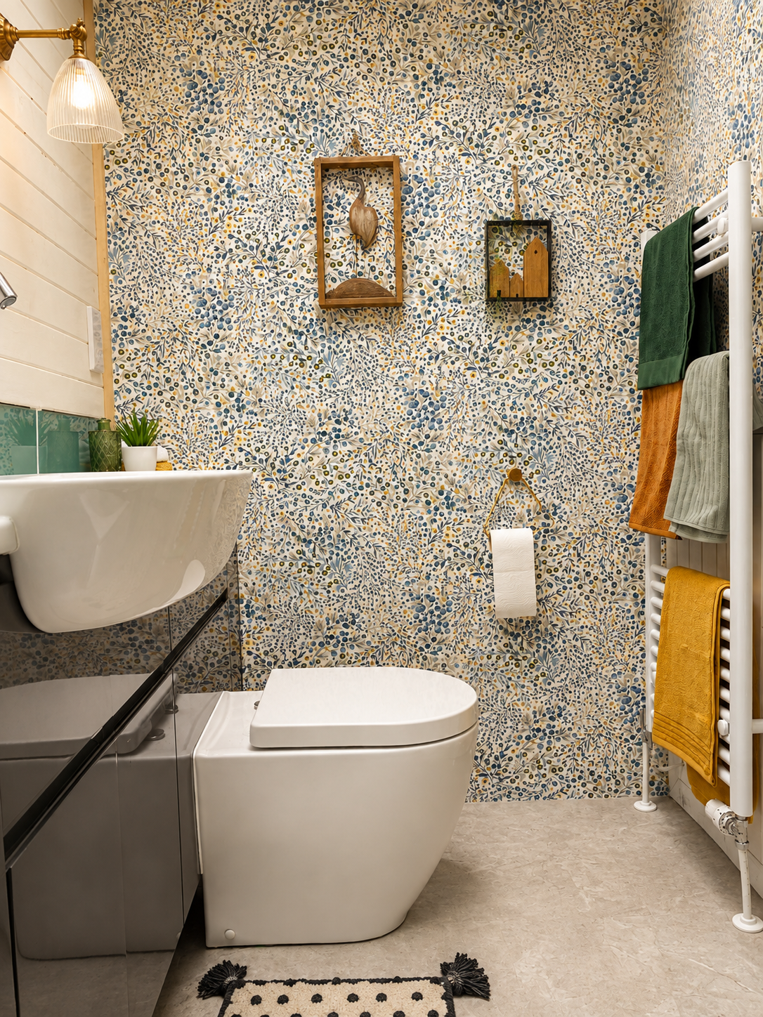 A feature wallpaper brings character and whimsy to the WC area. Locally sourced art adorns the wall.