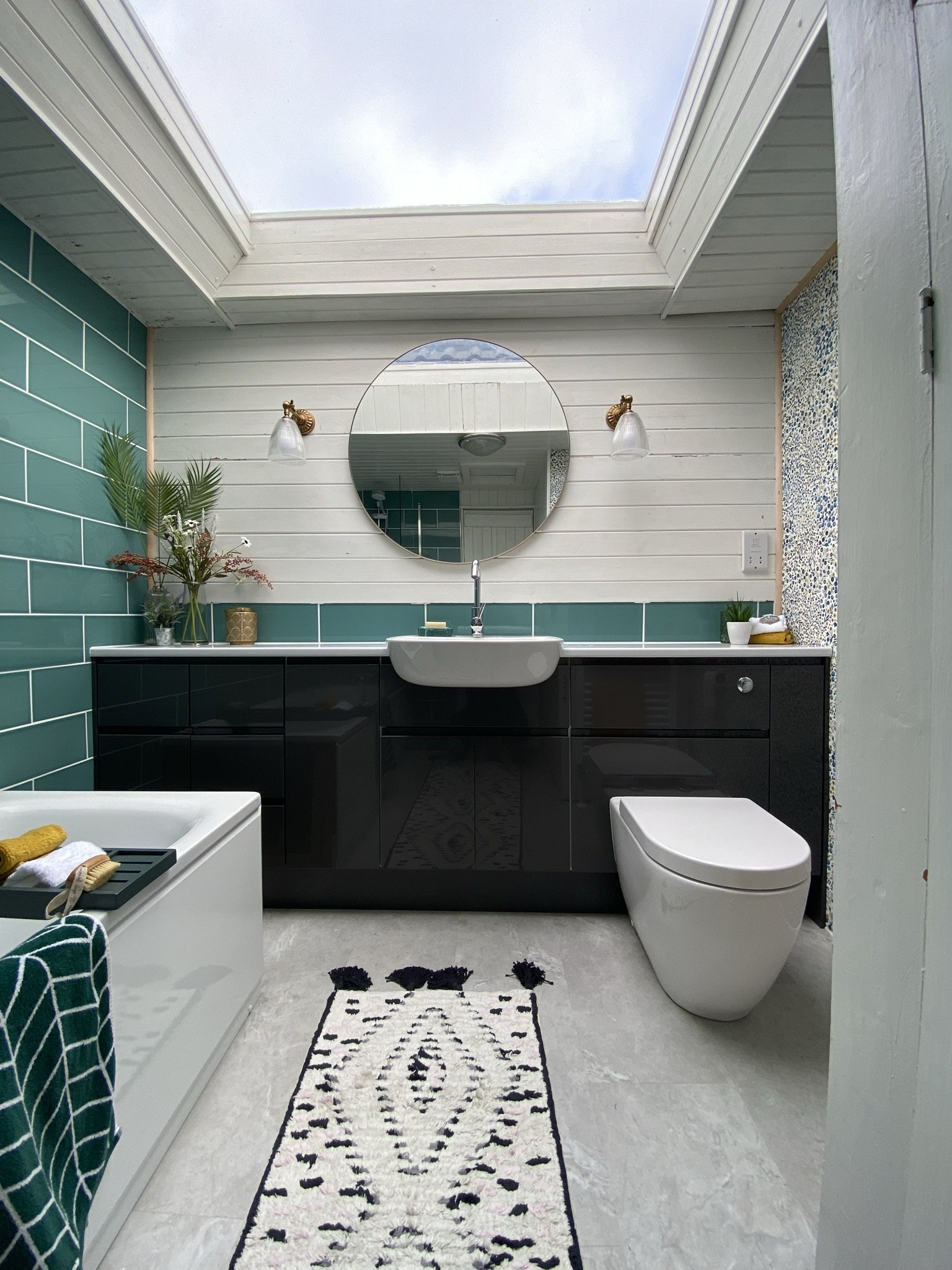 Tongue and groove painted white, statement tiles and large mirror adds luxury feel.