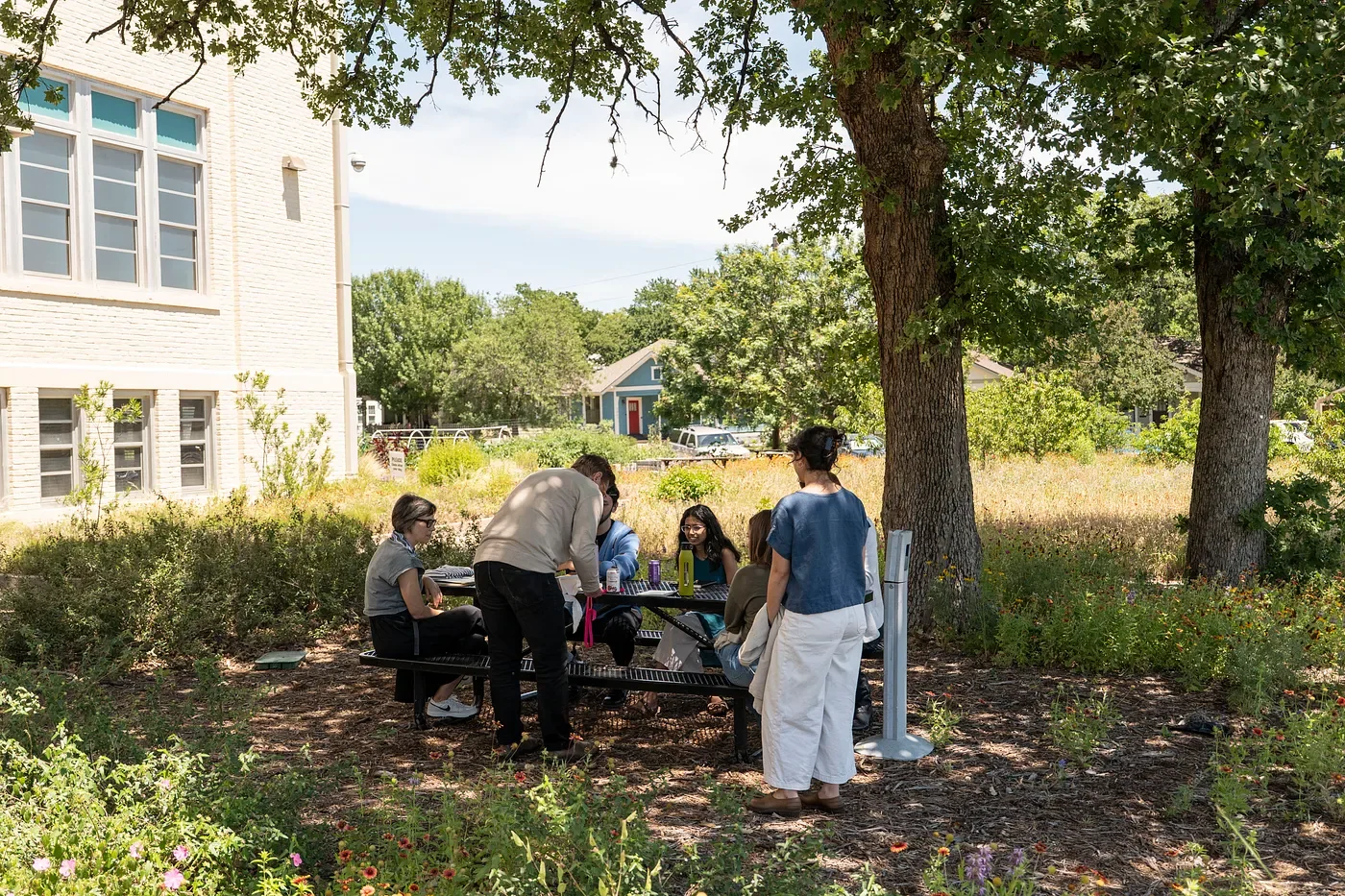 Fellows and facilitators seated at a picnic table outside