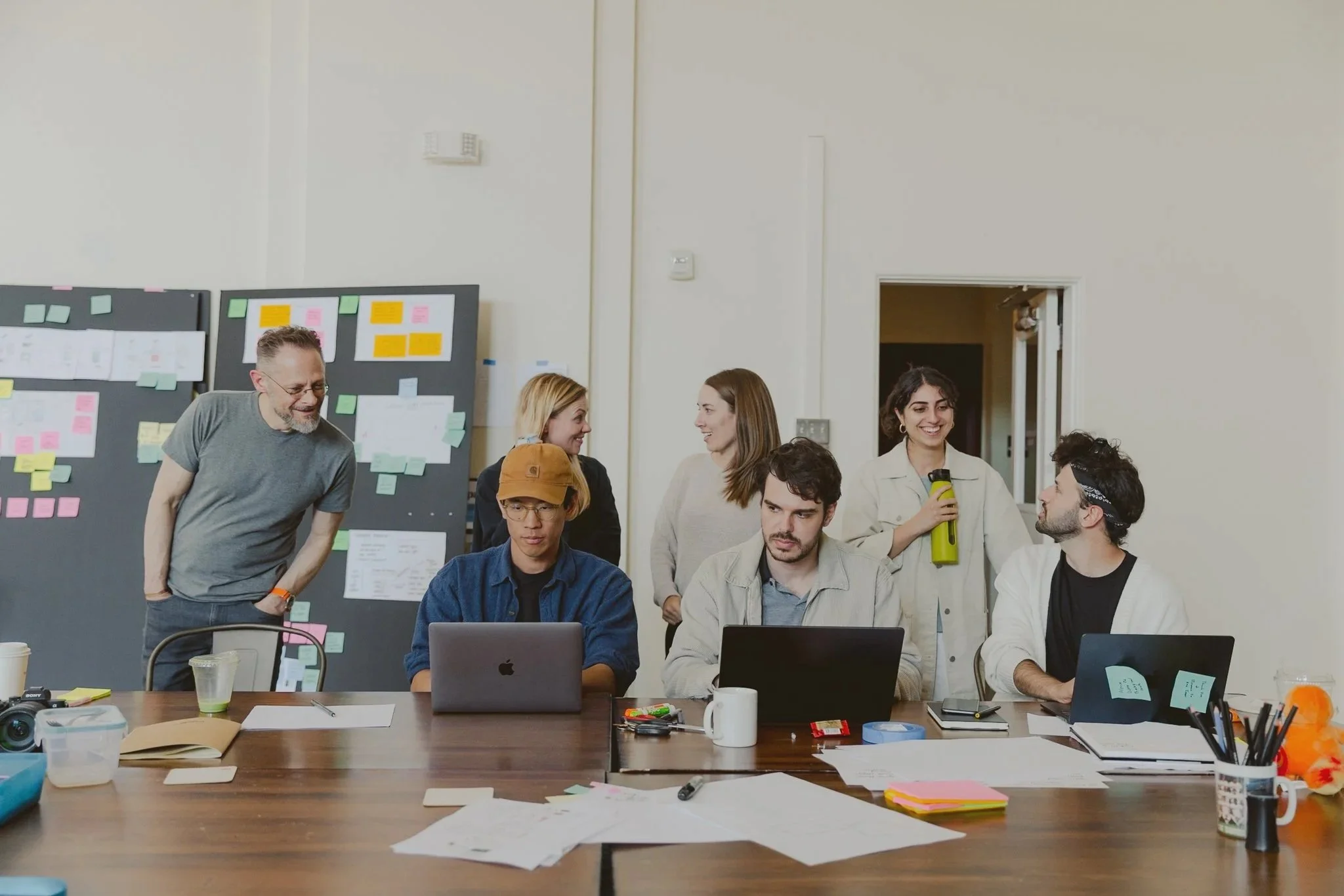 Fellows and Principal Designers collaborating behind laptops