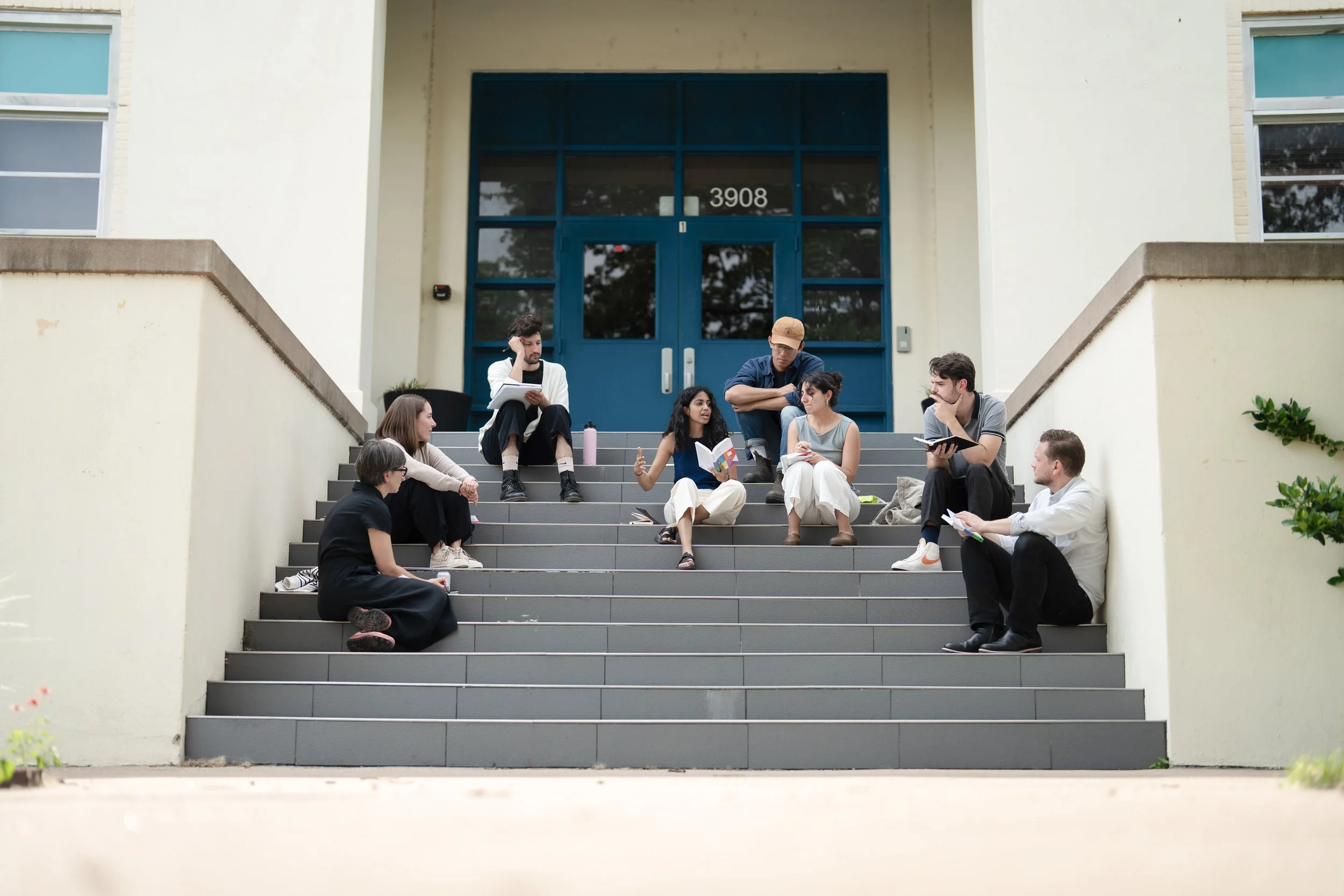 Fellows sitting and talking outside of the Baker School steps