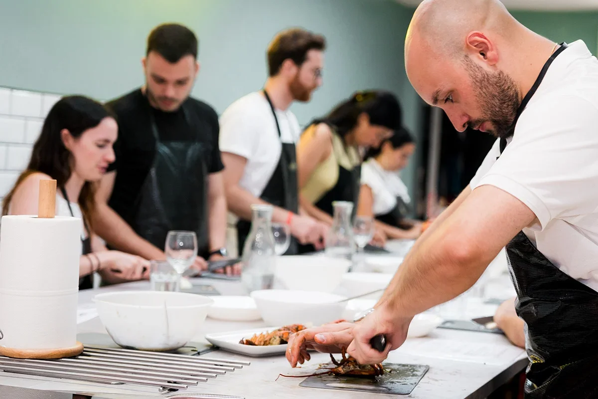 Group of participants collaborating in a hands-on cooking session, showing how Consumer Closeness Research UK facilitates co-creation and innovation workshops to connect brands with real consumers for authentic product development insights.