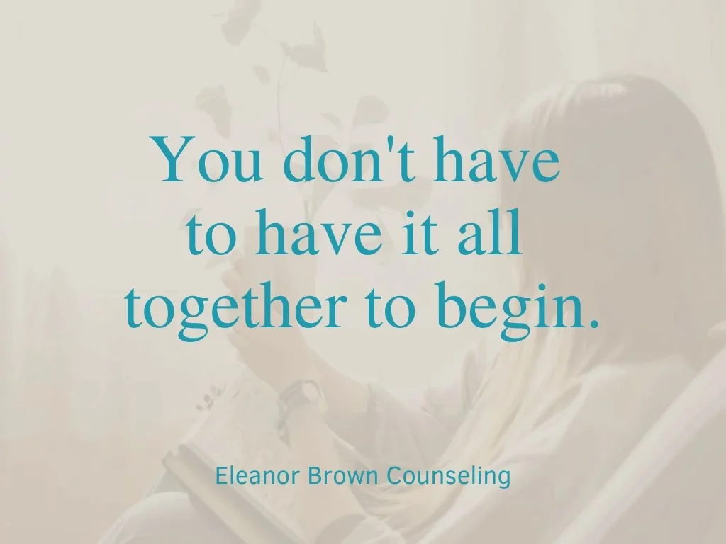 A woman sitting on a couch holding a book with the text overlay reading "You don't have to have it together to begin," representing the first step of learning how to prepare for therapy.