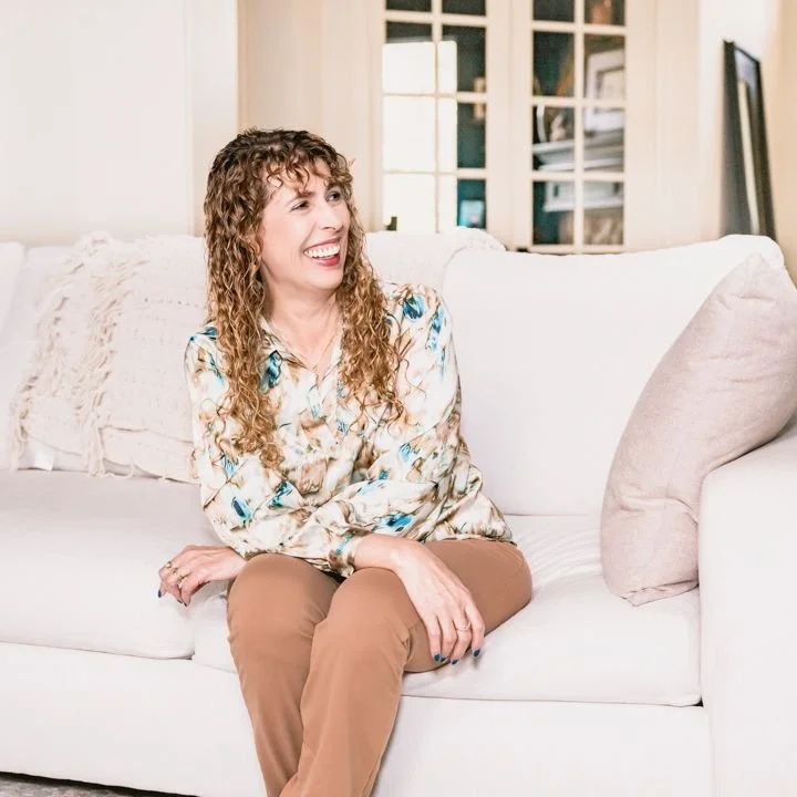 Licensed professional counselor in Killeen, TX smiling on her couch, representing faith-based therapy and emotional healing.