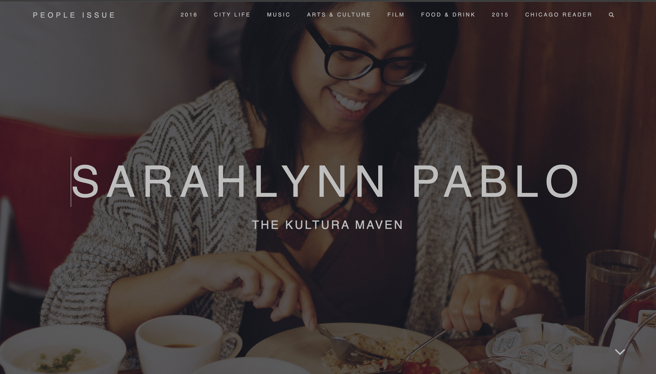 Sarahlynn Pablo, "The Kultura Maven," smiling and eating, Photo by Danielle A. Scruggs