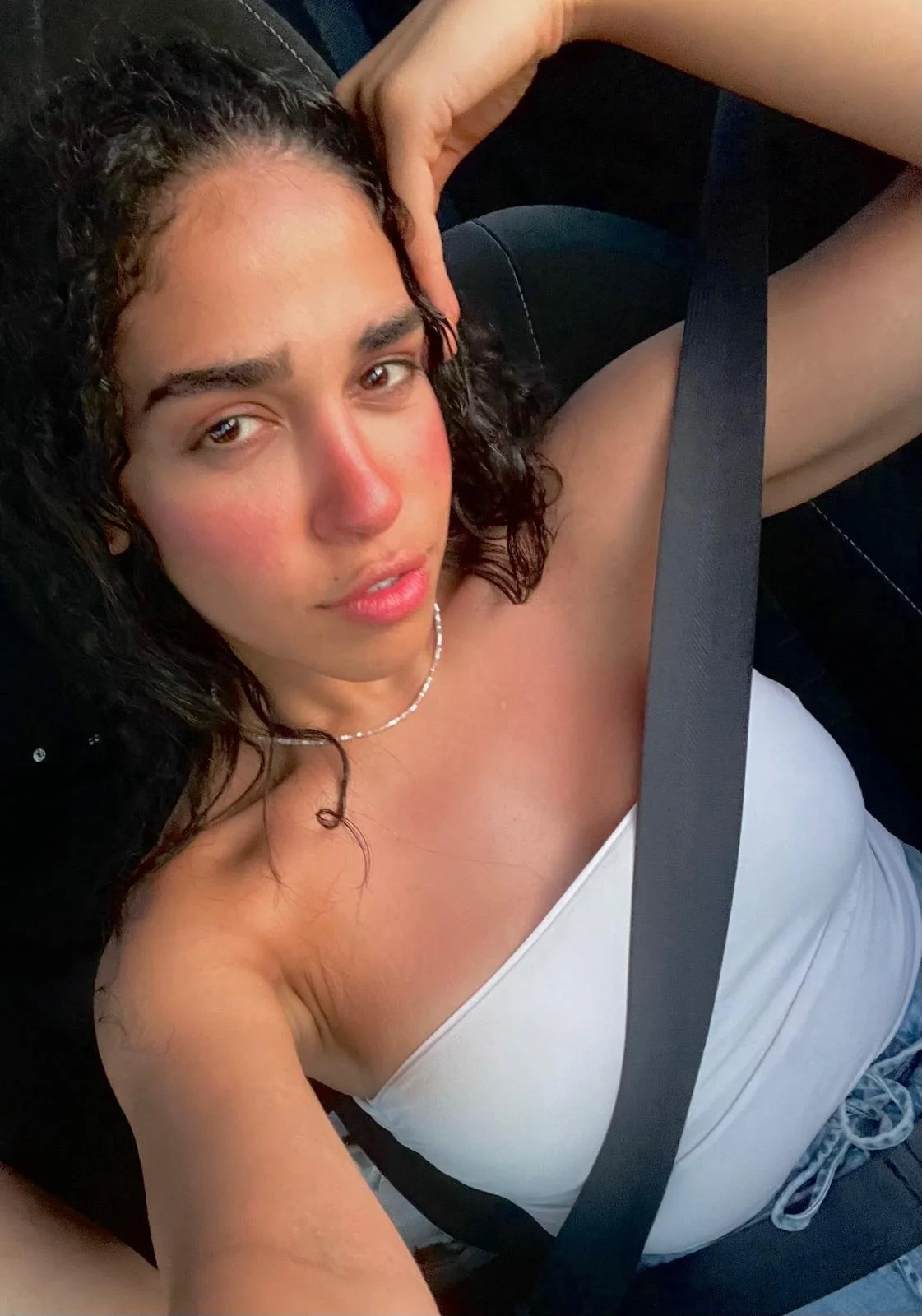 Black and white photo of a woman holding three precision knives close to her face, with a serious expression.