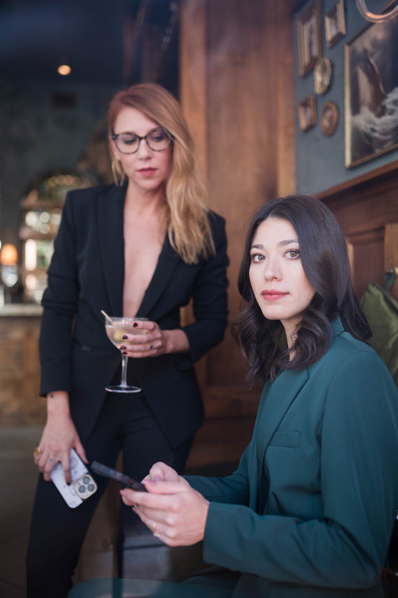 Winnie holding a martini in a speakeasy window with Tyler, an authentic branding photo from REM Real Estate Marketing