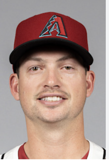 Young man wearing a red baseball cap with an 'A' logo and a white jersey.