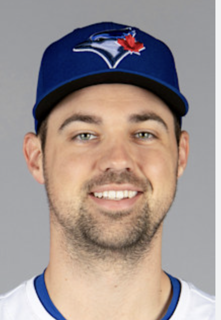 Photo of a man wearing a Toronto Blue Jays baseball cap with the team logo and a red maple leaf, smiling at the camera.