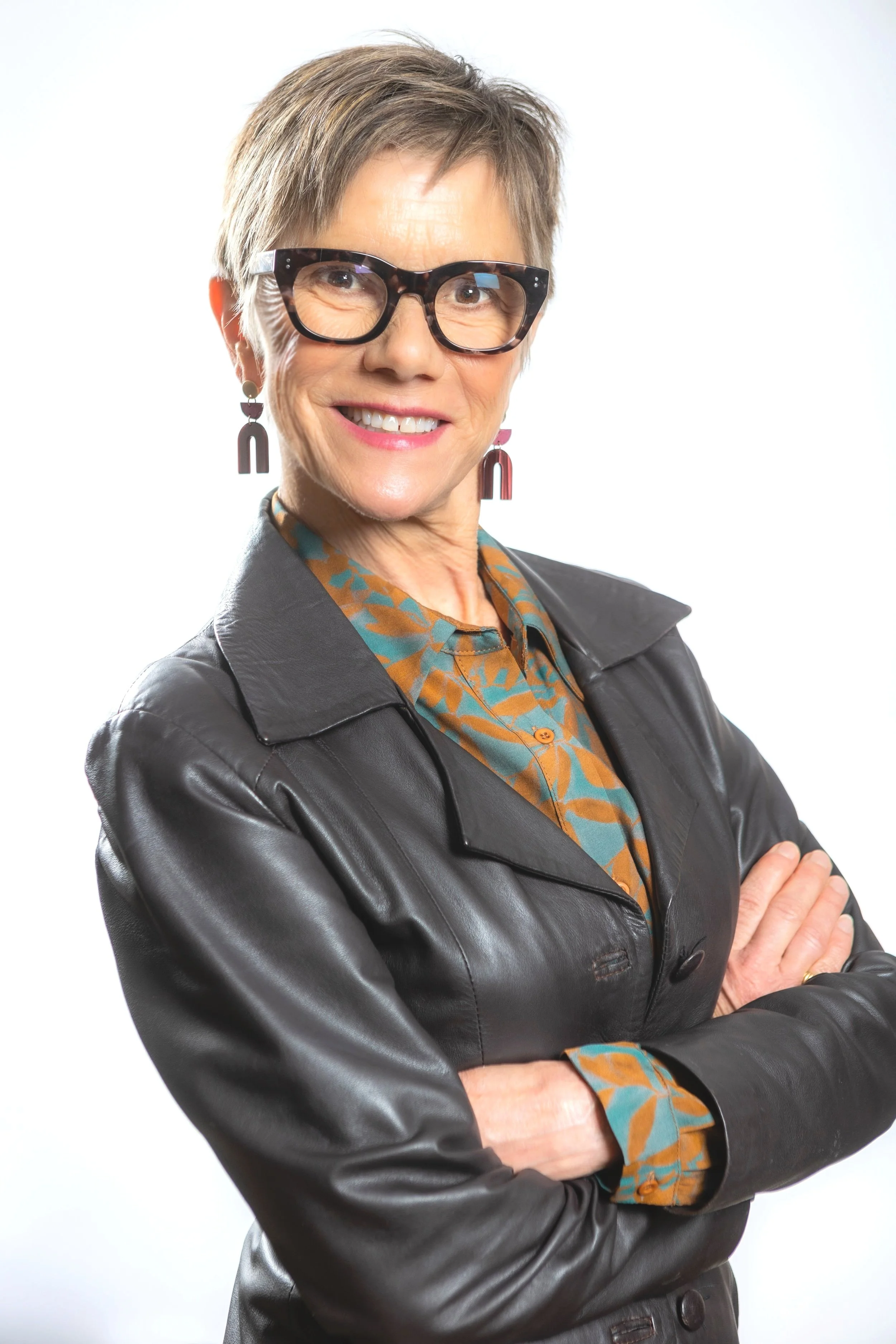 Picture of our woman with short hair wearing a leather blazer