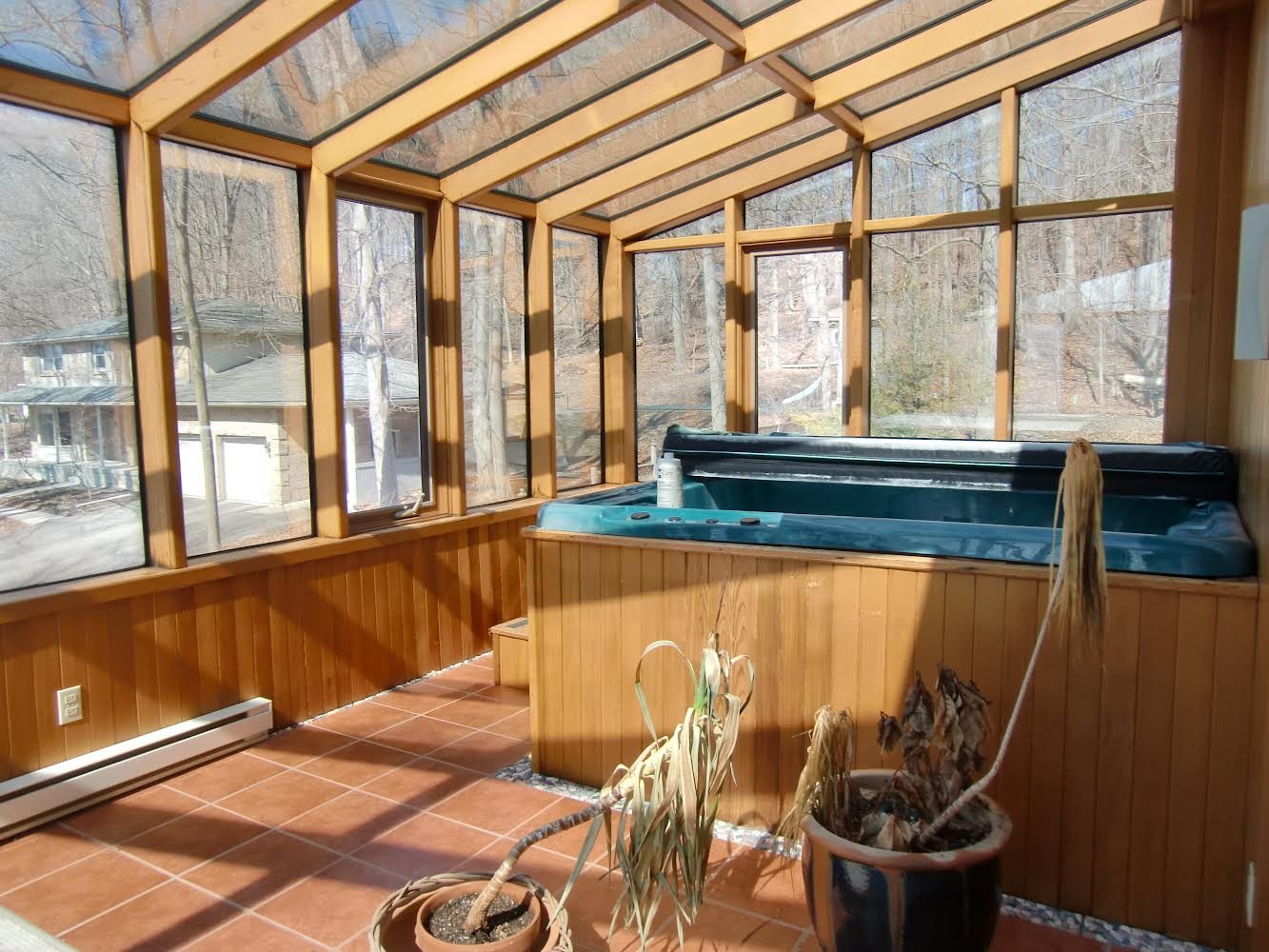 Before picture of upper floor with hot tub, illustrating drainage issues in the home's original state prior to renovation.