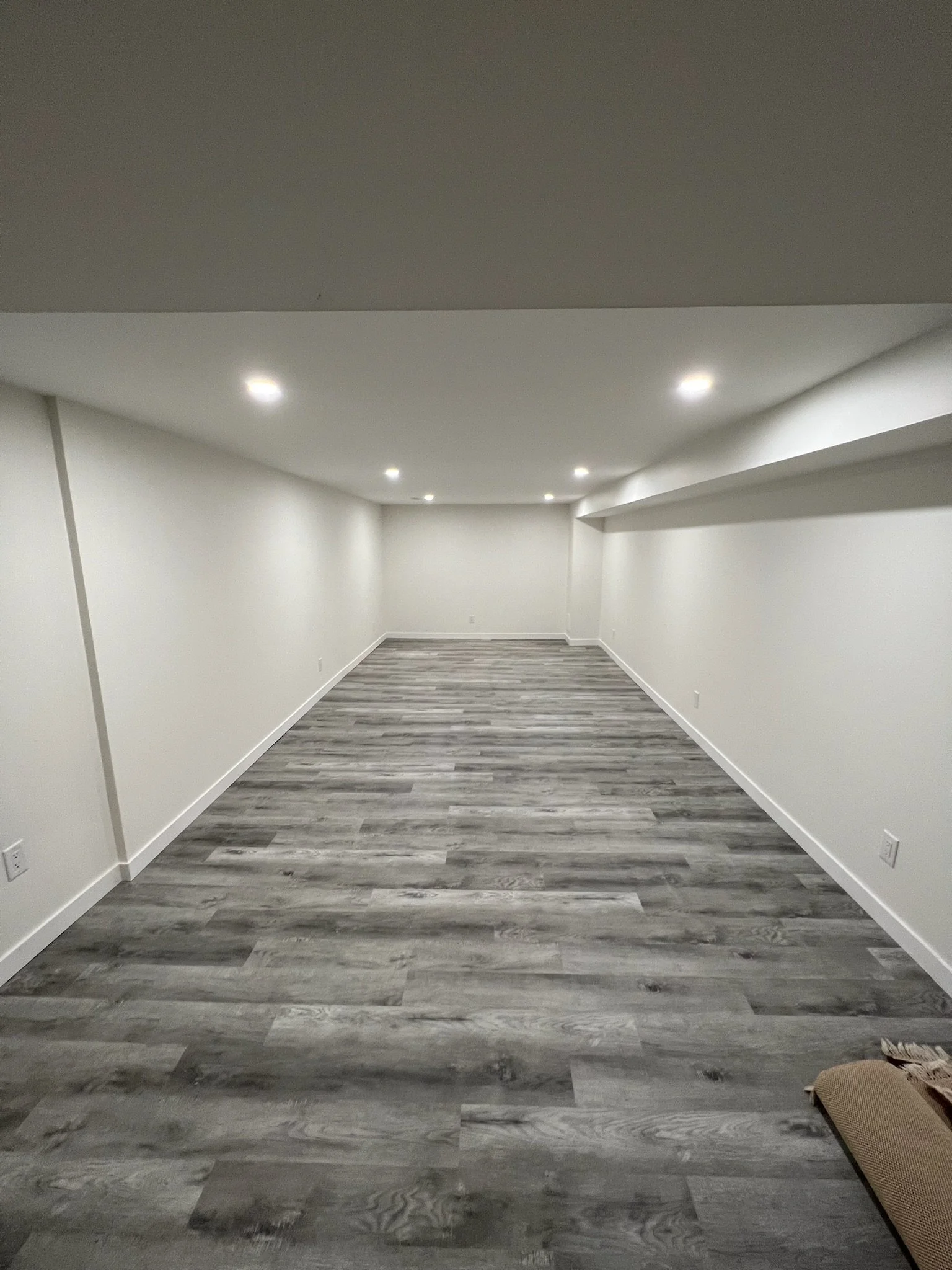 Another view of the completed basement renovation in West London by Burcon Construction, illustrating the transformation and improved aesthetics.