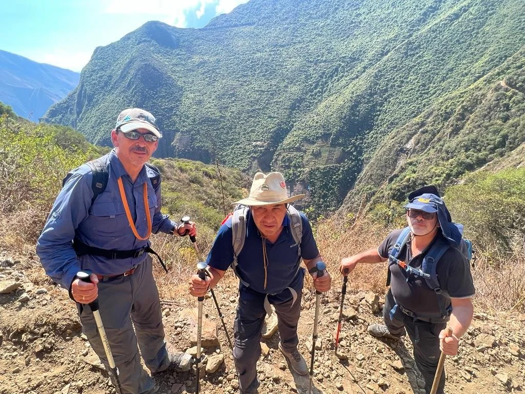 Group of trekkers exploring the Choquequirao archaeological site in the Andes.