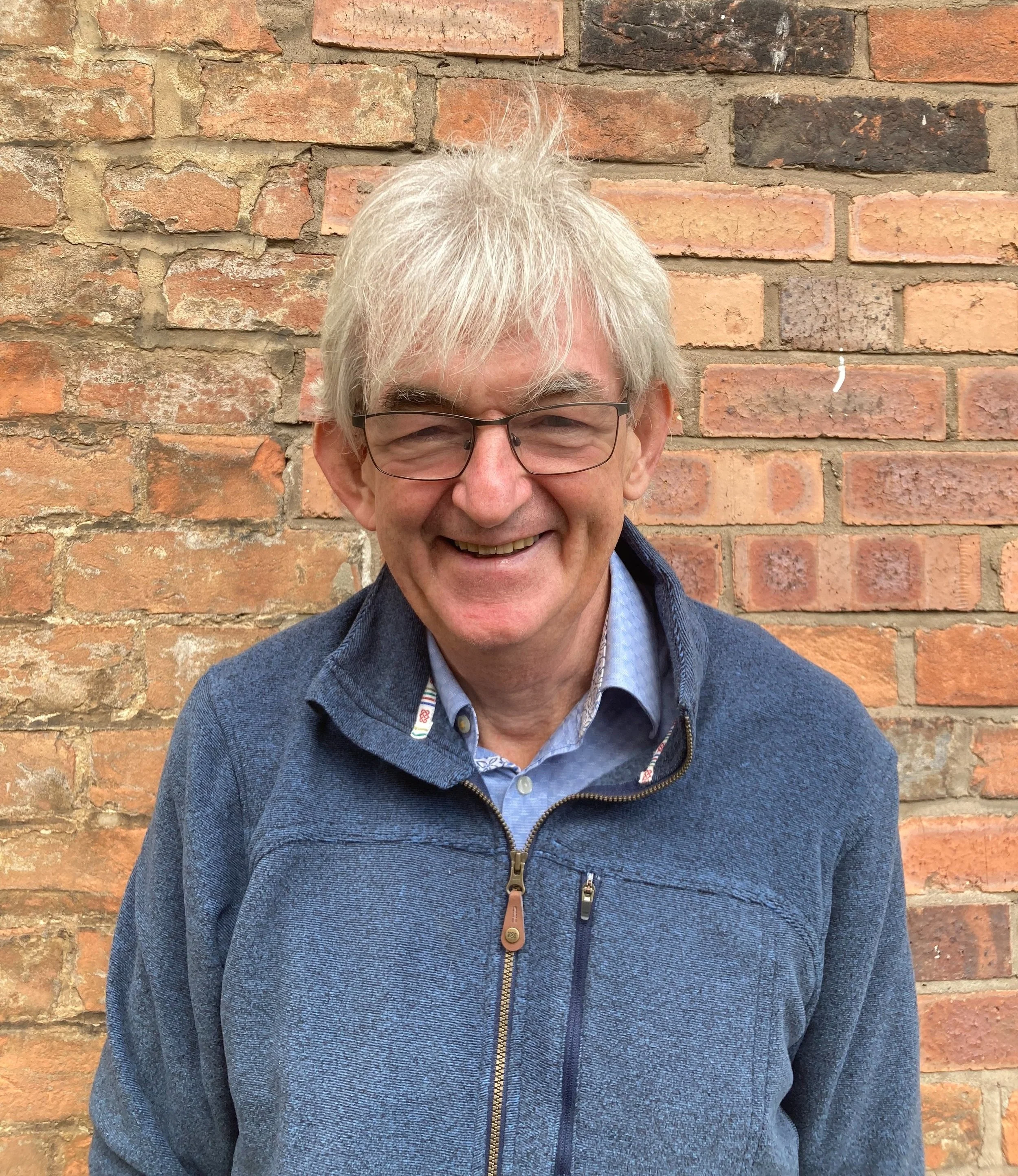 Mel Young, smiling at the camera