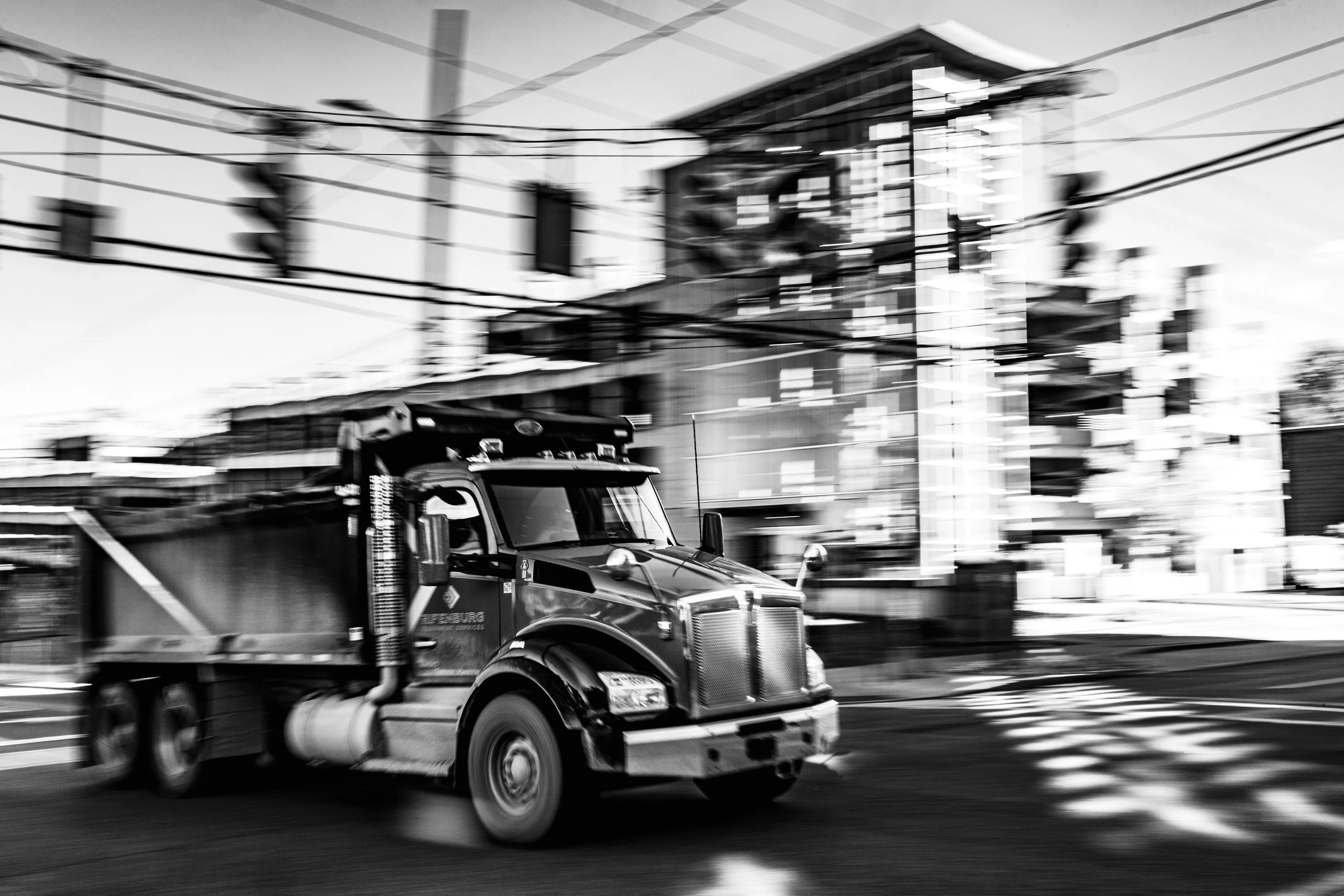 A hauling truck drives past University Avenue in Syracuse, New York, on Oct. 9, 2025.