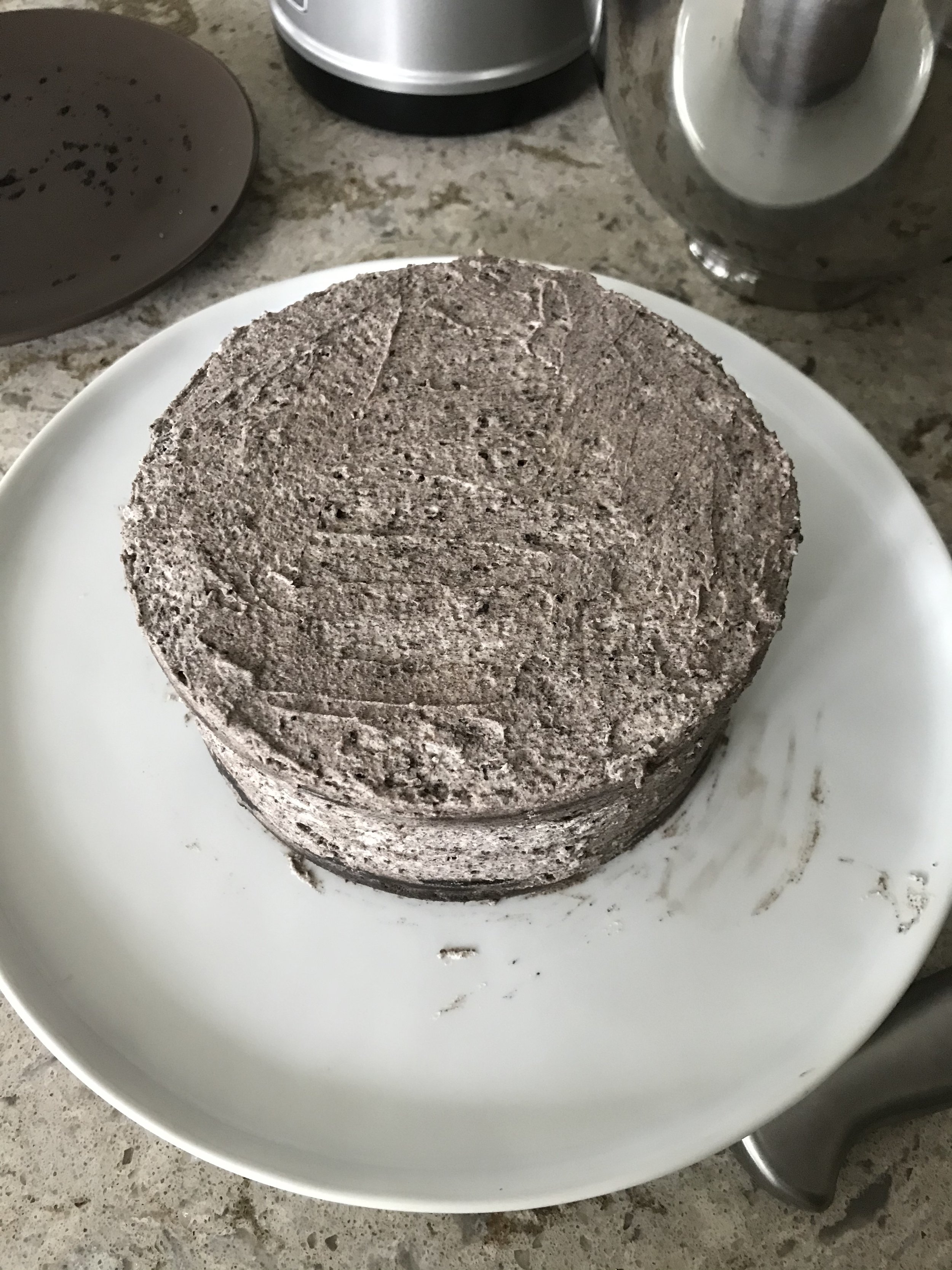  Fully iced triple layer cake with oreo cream covering the cake all over 