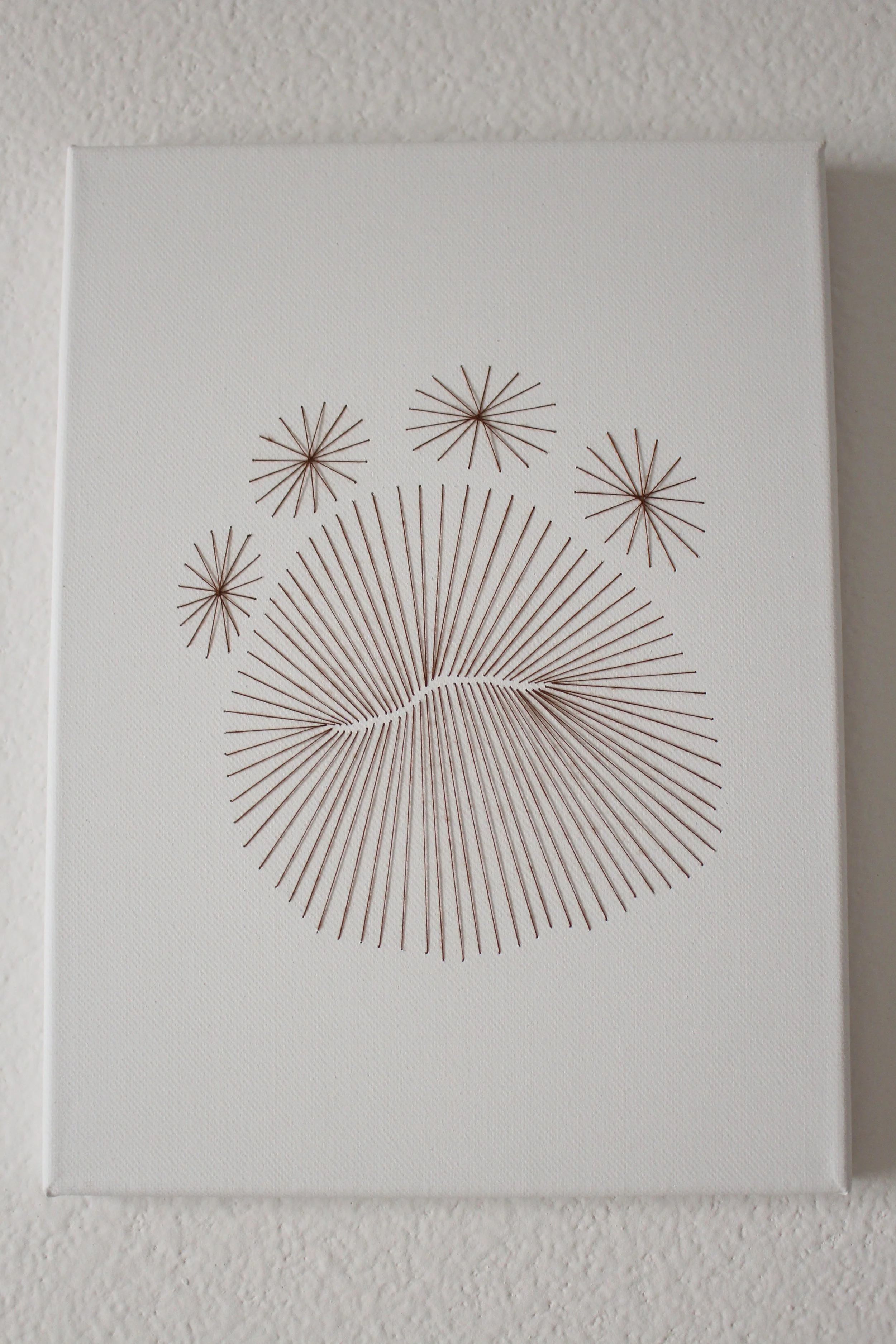  Darn brown dinosaur footprint sewn into a canvas 