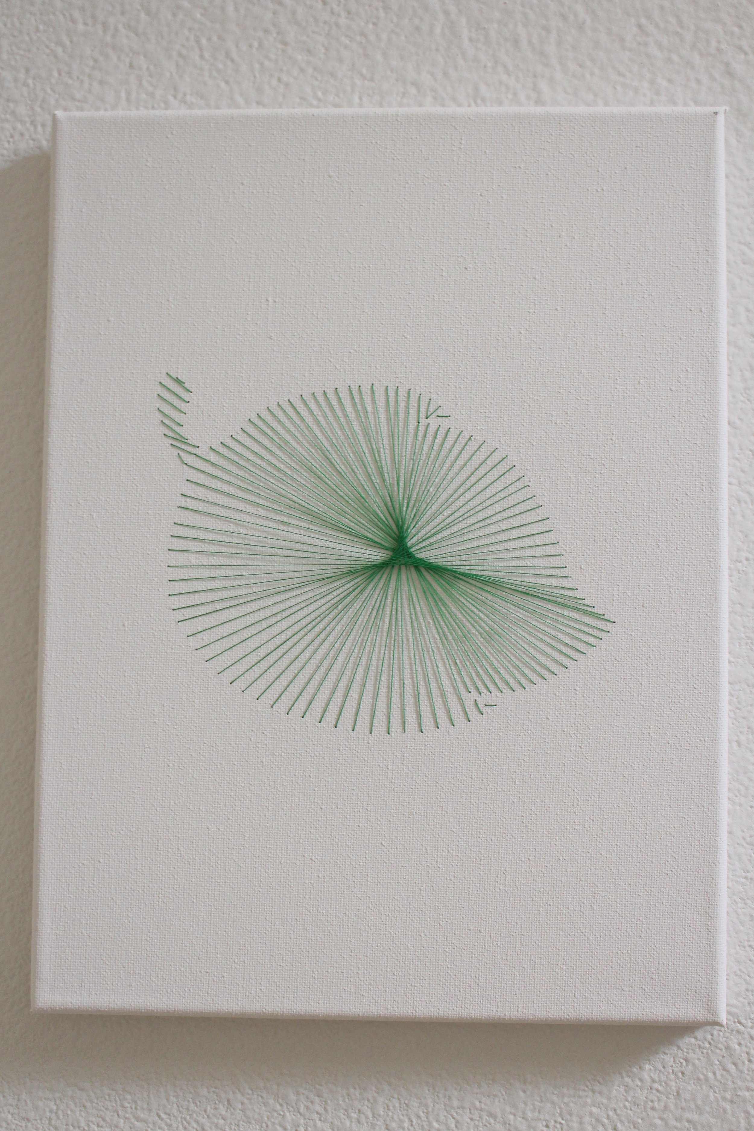  Green leaf sewn onto a canvas 