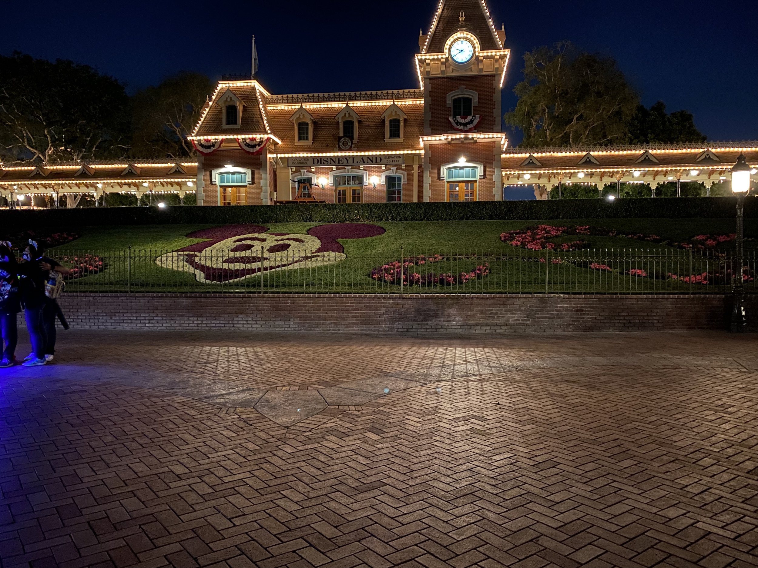  Nighttime view of the Disneyland railroad and the Mickey hedge at the Disneyland entrance 