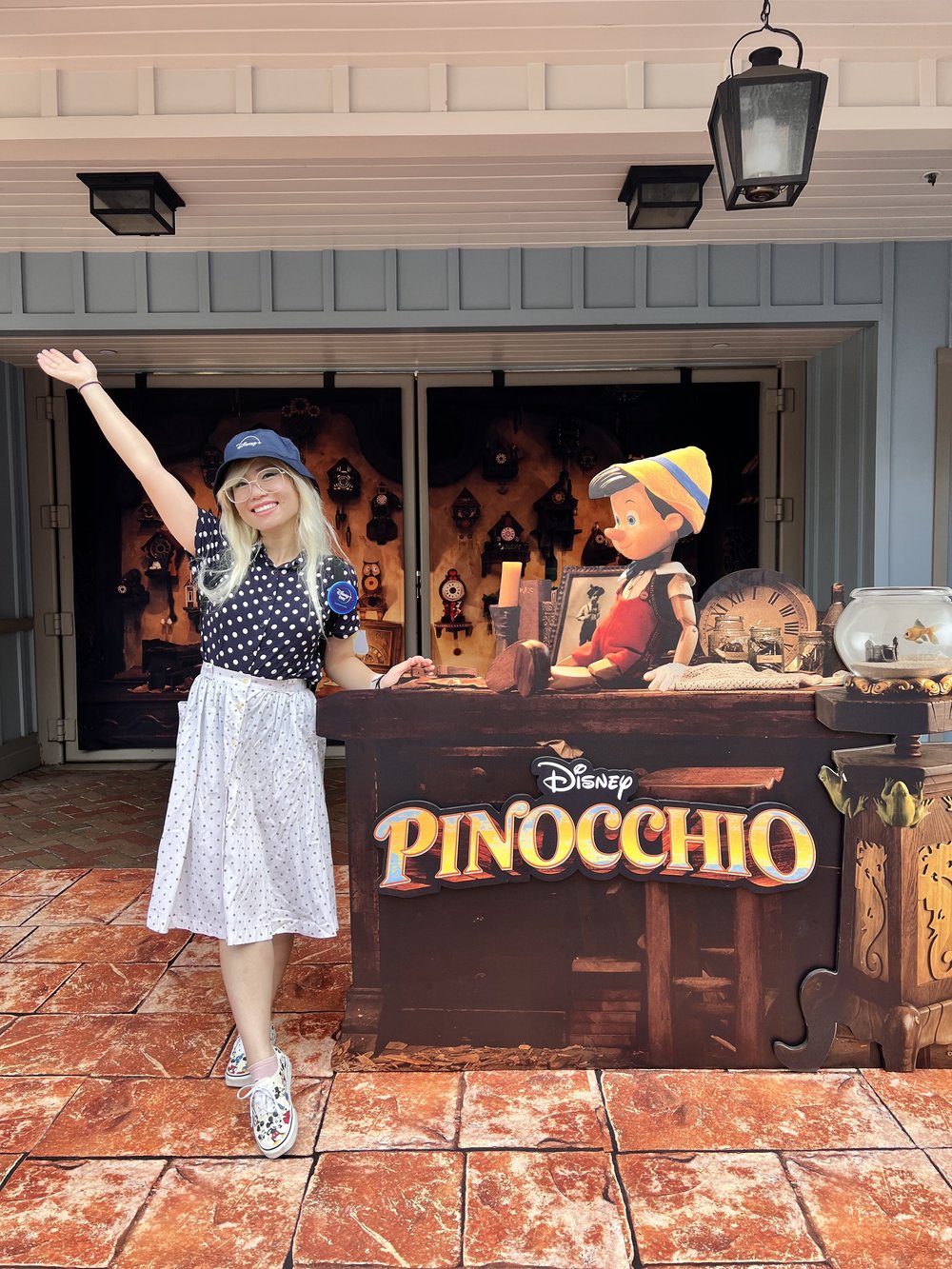  Girl with a Disney+ bucket hat standing next to a Pinocchio photo op set 