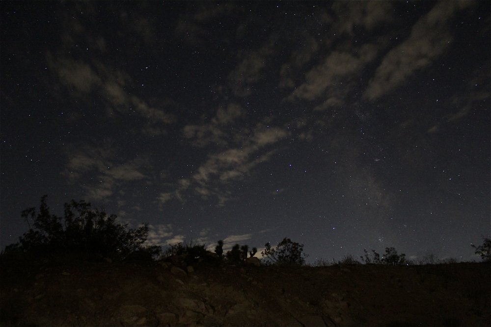  View of the stars in the night sky with a view of clouds 