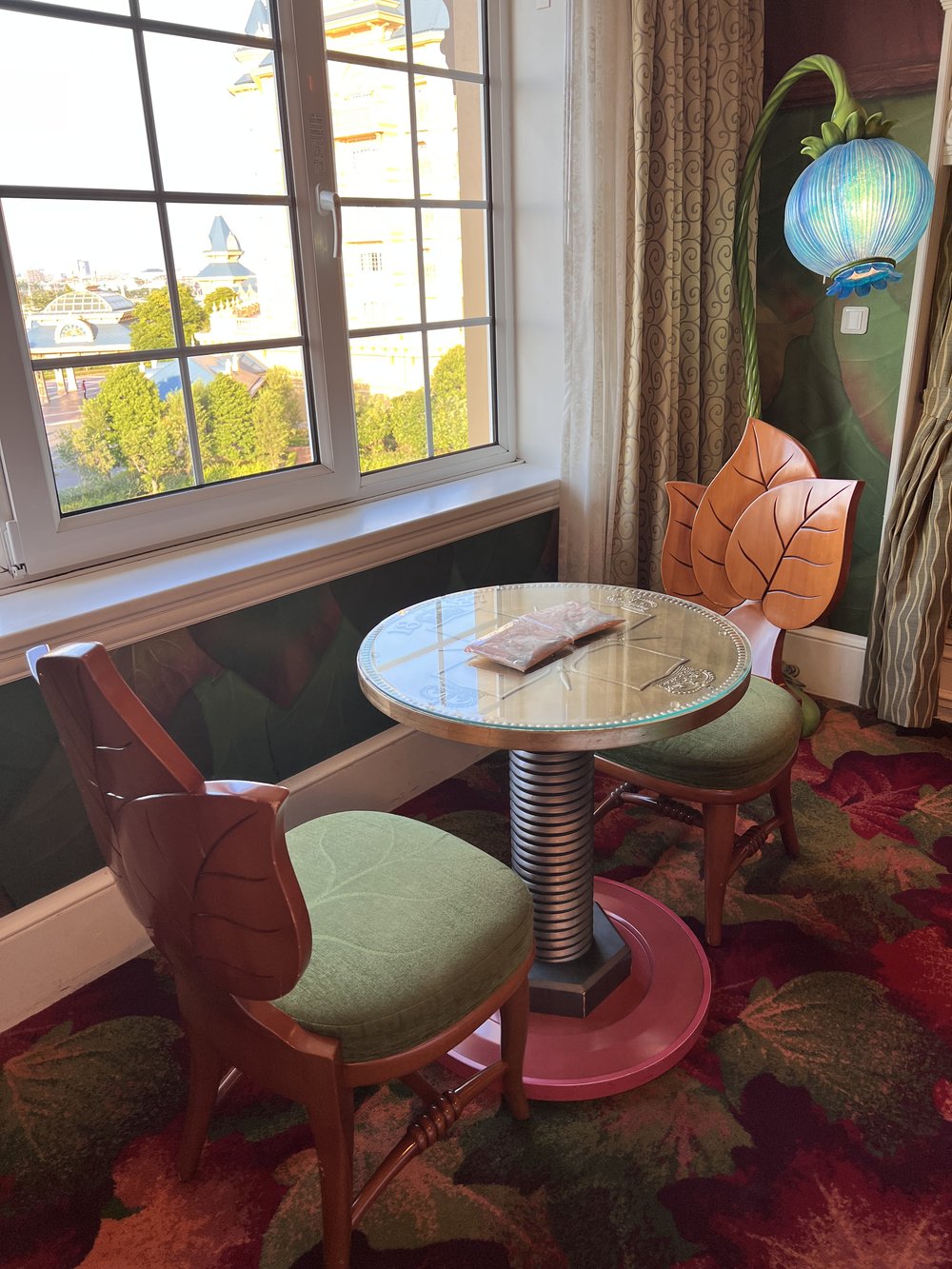  Two chairs that look like leaves and a table that looks like a screw with a lamp that looks like a blueberry in the Tinkerbell room in Tokyo Disneyland Hotel 