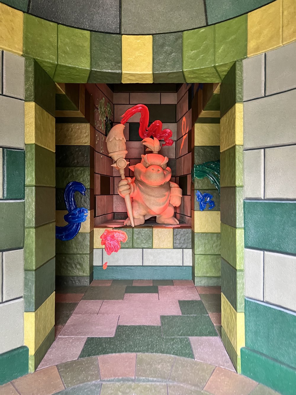  Bowser Jr. statue in a room with green, yellow, and gray bricks 