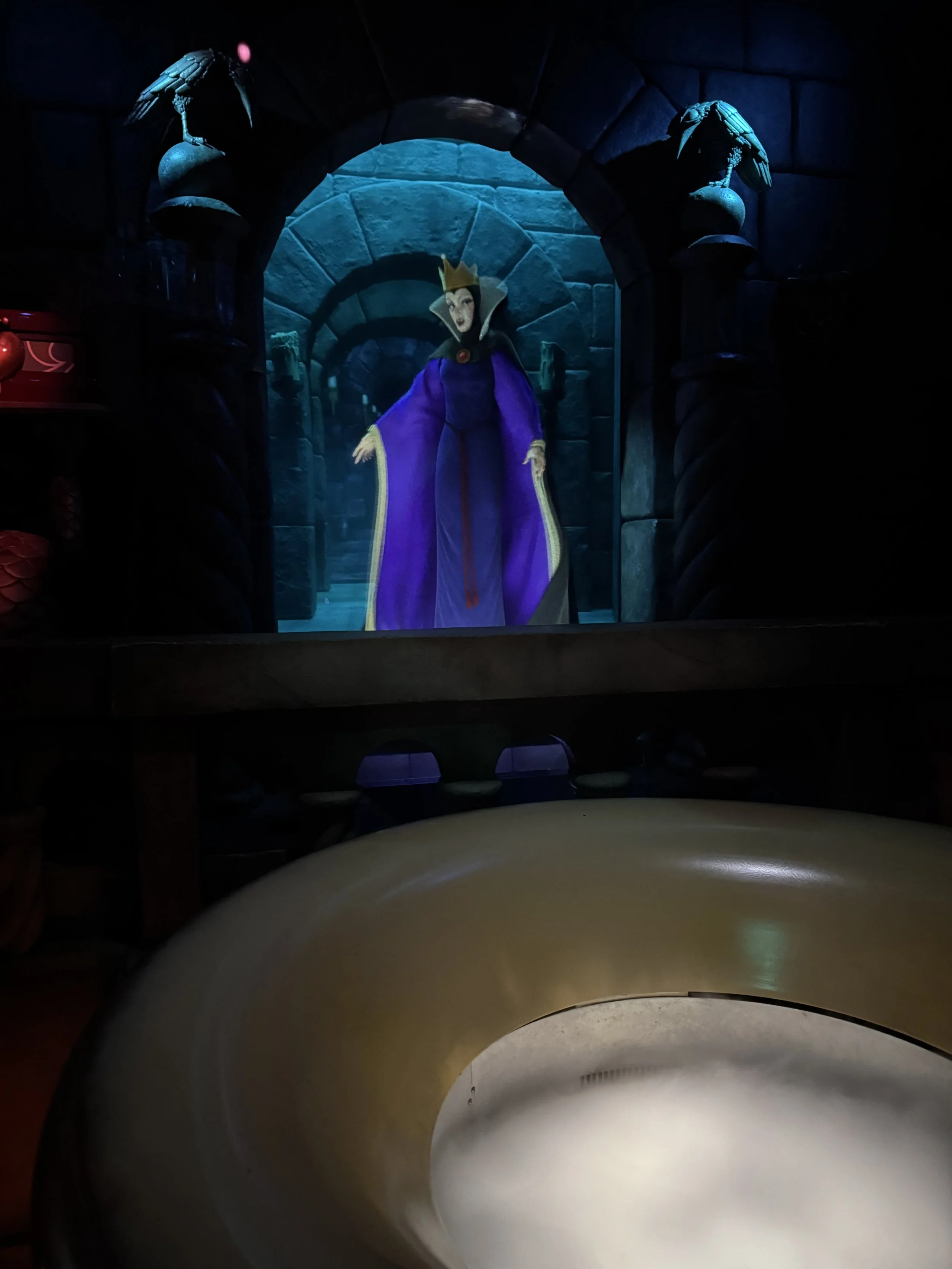  The evil queen from Snow White in front of a cauldron 