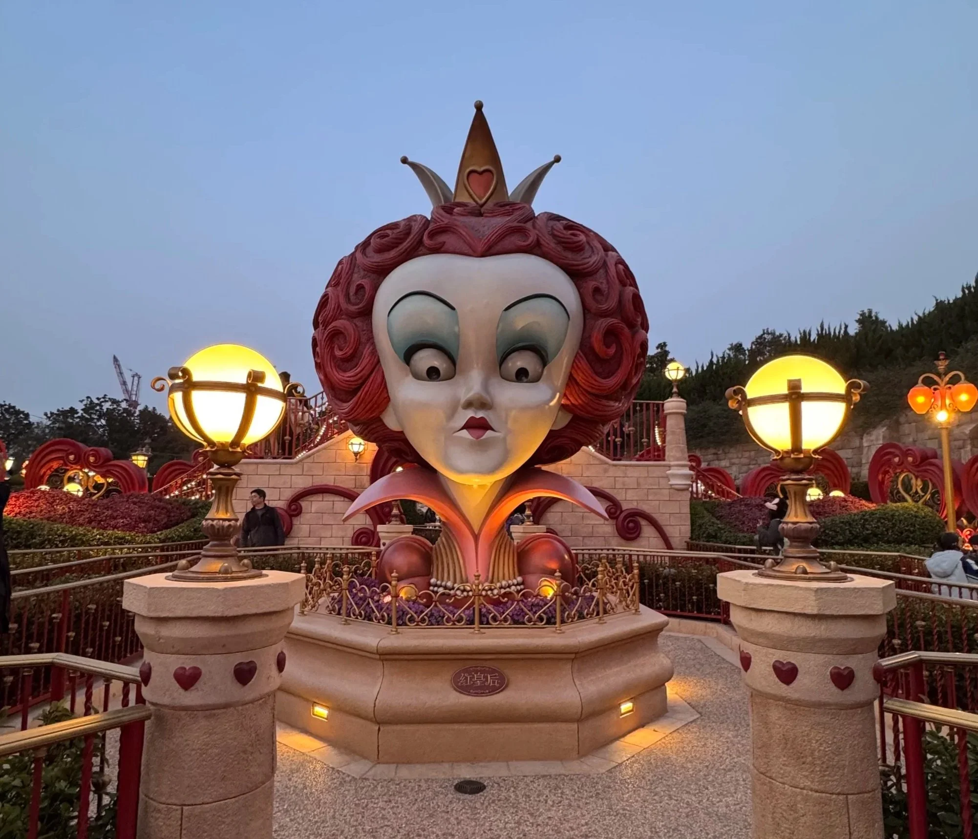  large statue of the queen of hearts Tim Burton version in the center of the queen of hearts garden 