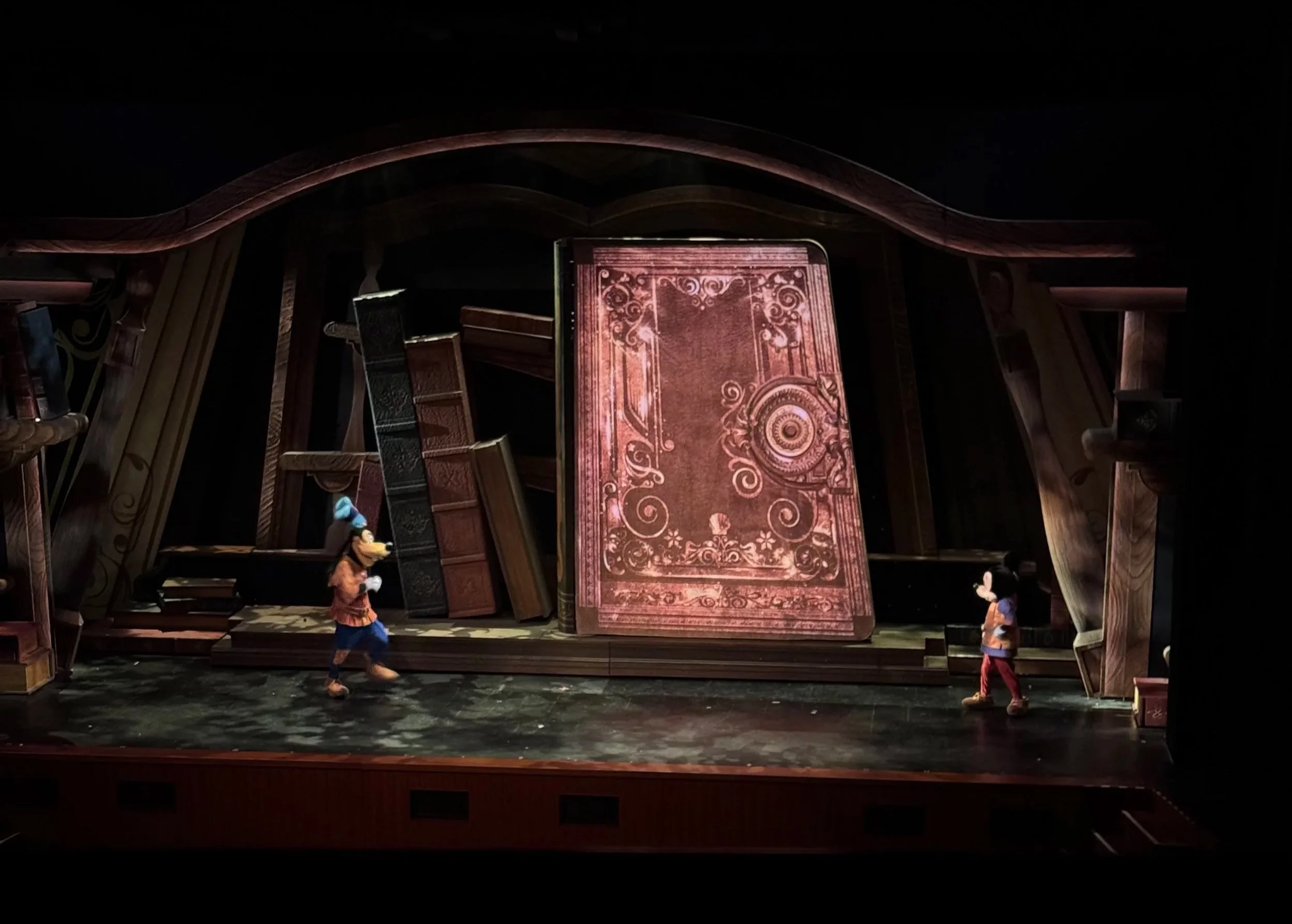  Mickey and Goofy in front of a giant storybook 