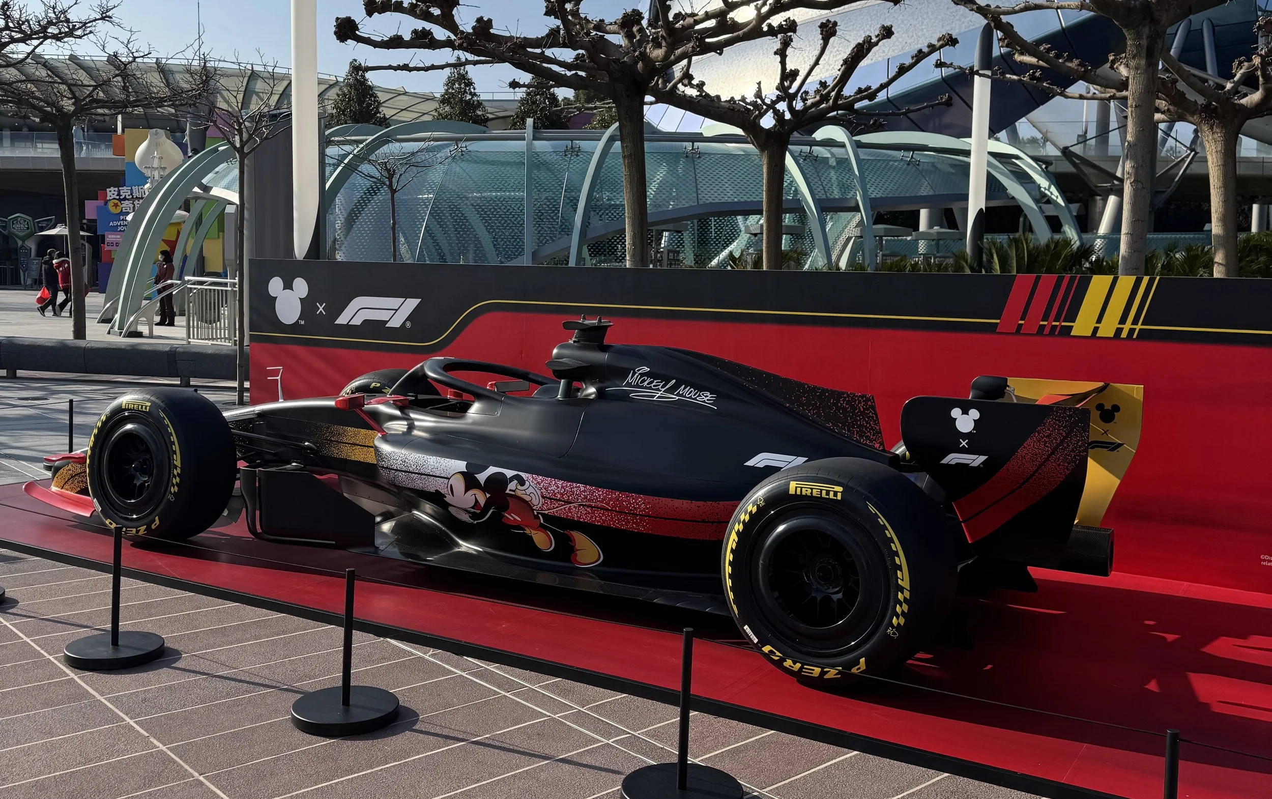 Disney x F1 car in front of Tron at Tomorrowland in Shanghai Disneyland