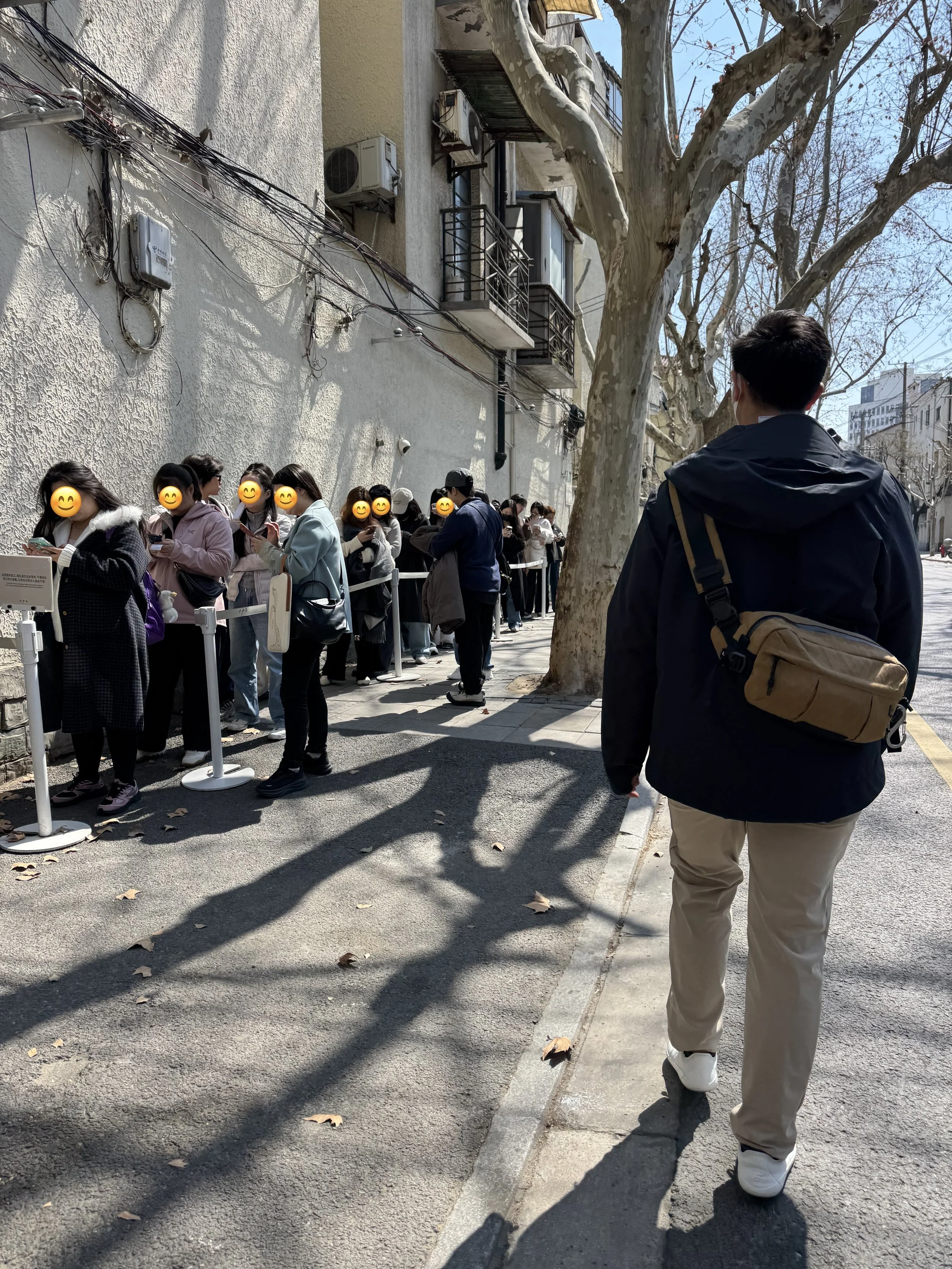 Line of people against a building