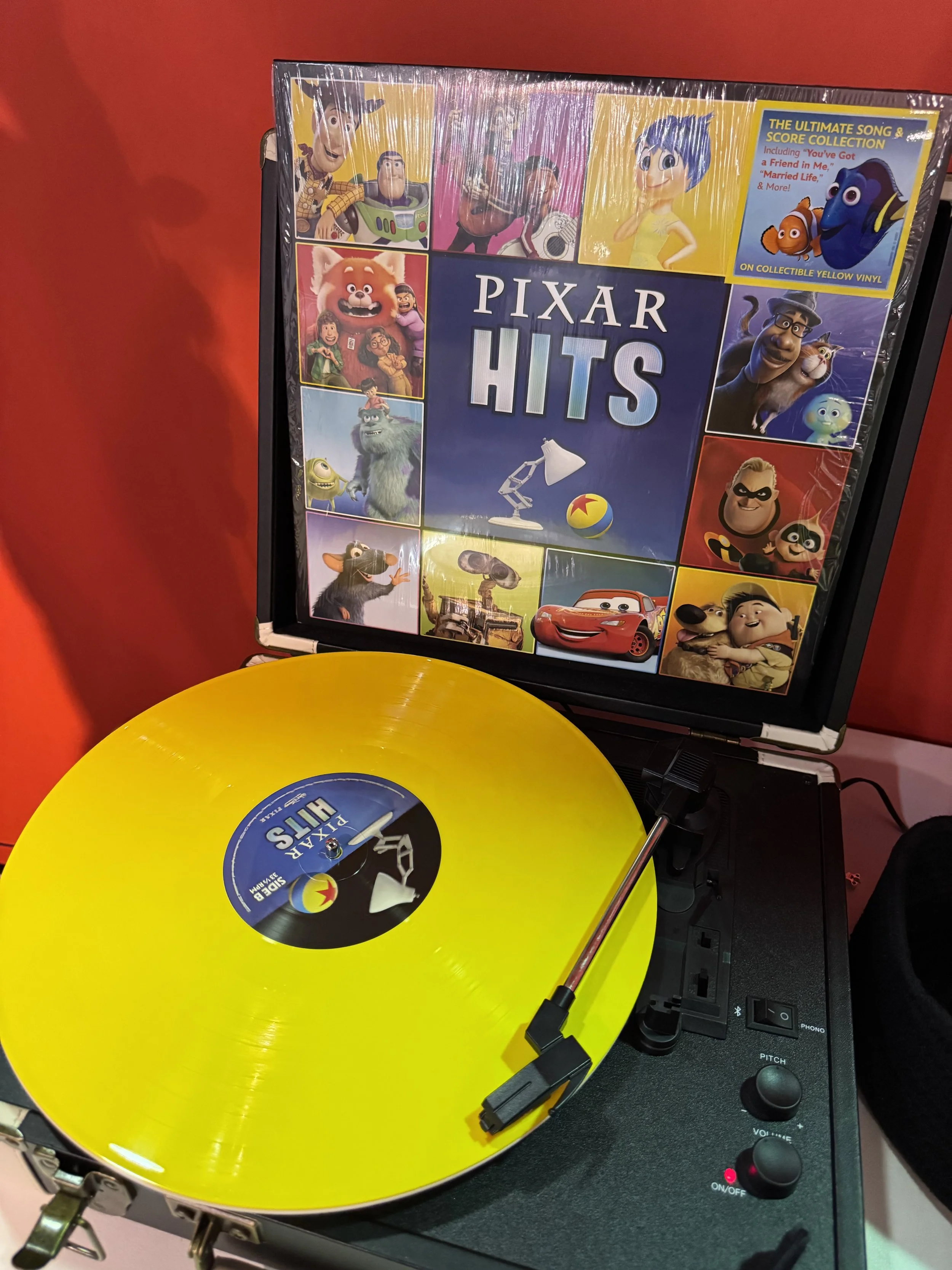 Listening to the Pixar hits vinyl record at Disney Music Emporium listening lounge
