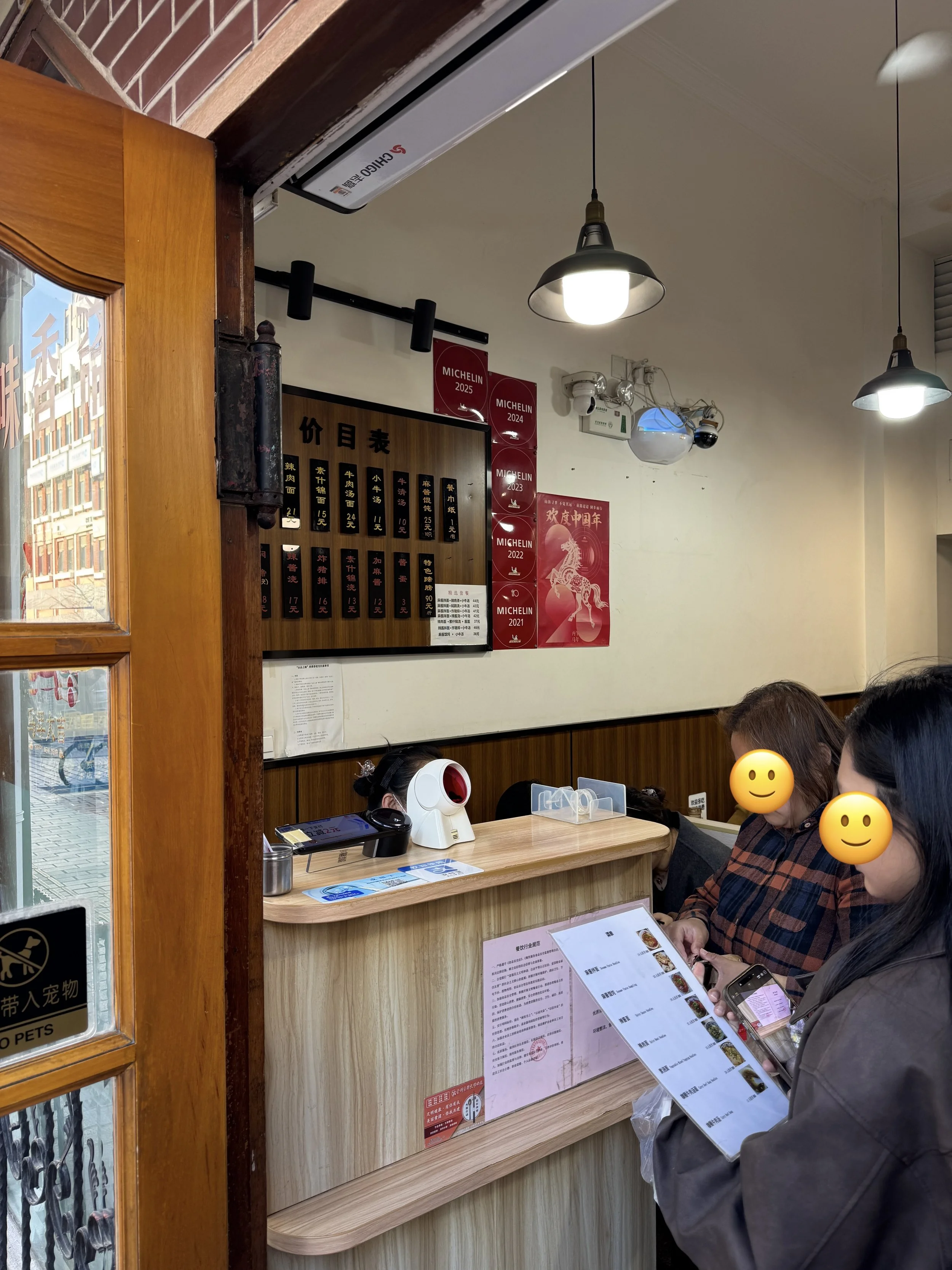 Ordering noodles at the front desk before being seated