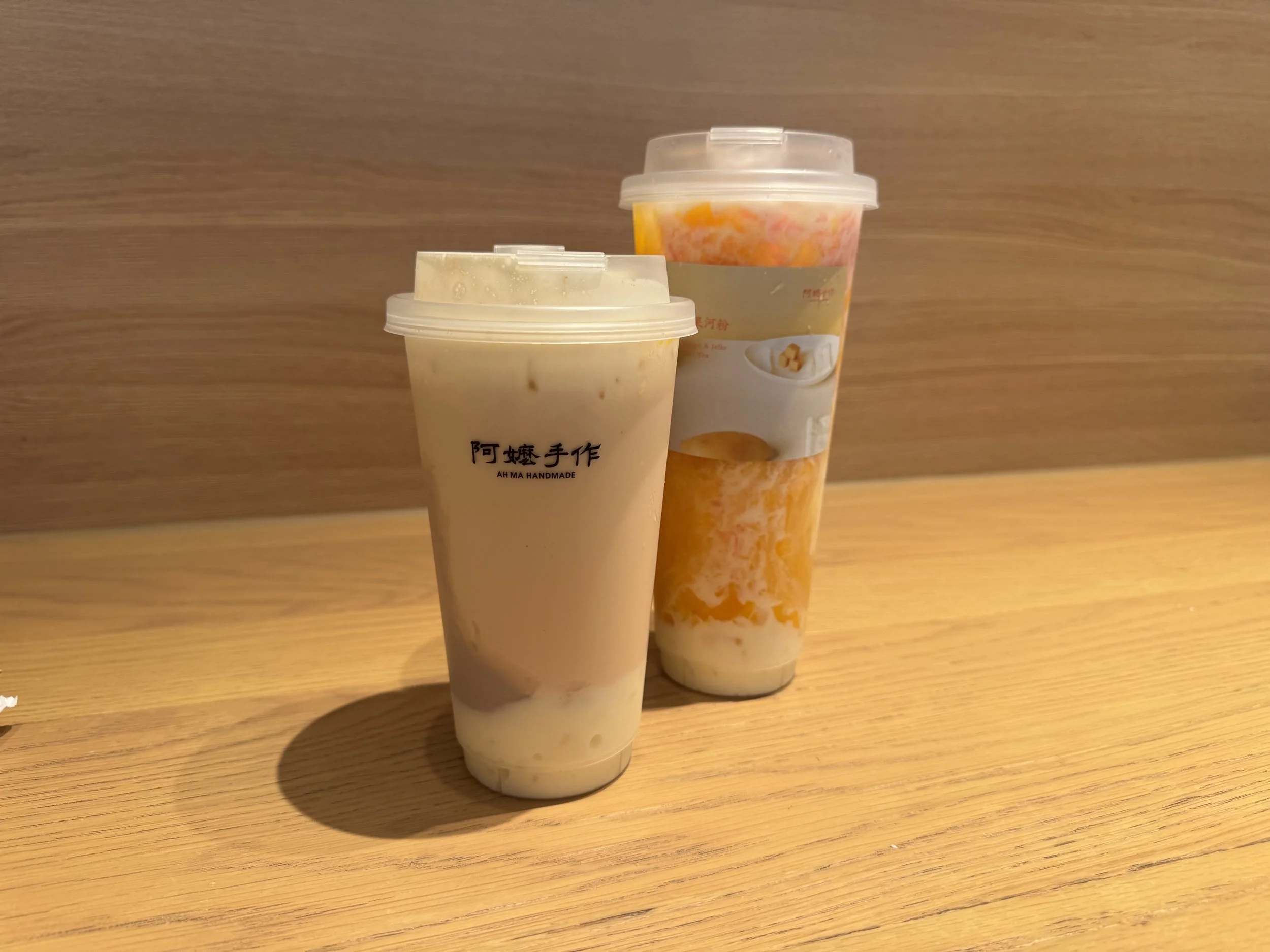 Small milk tea with rice mochi and taro mash and a large mango smoothie with rice mochi