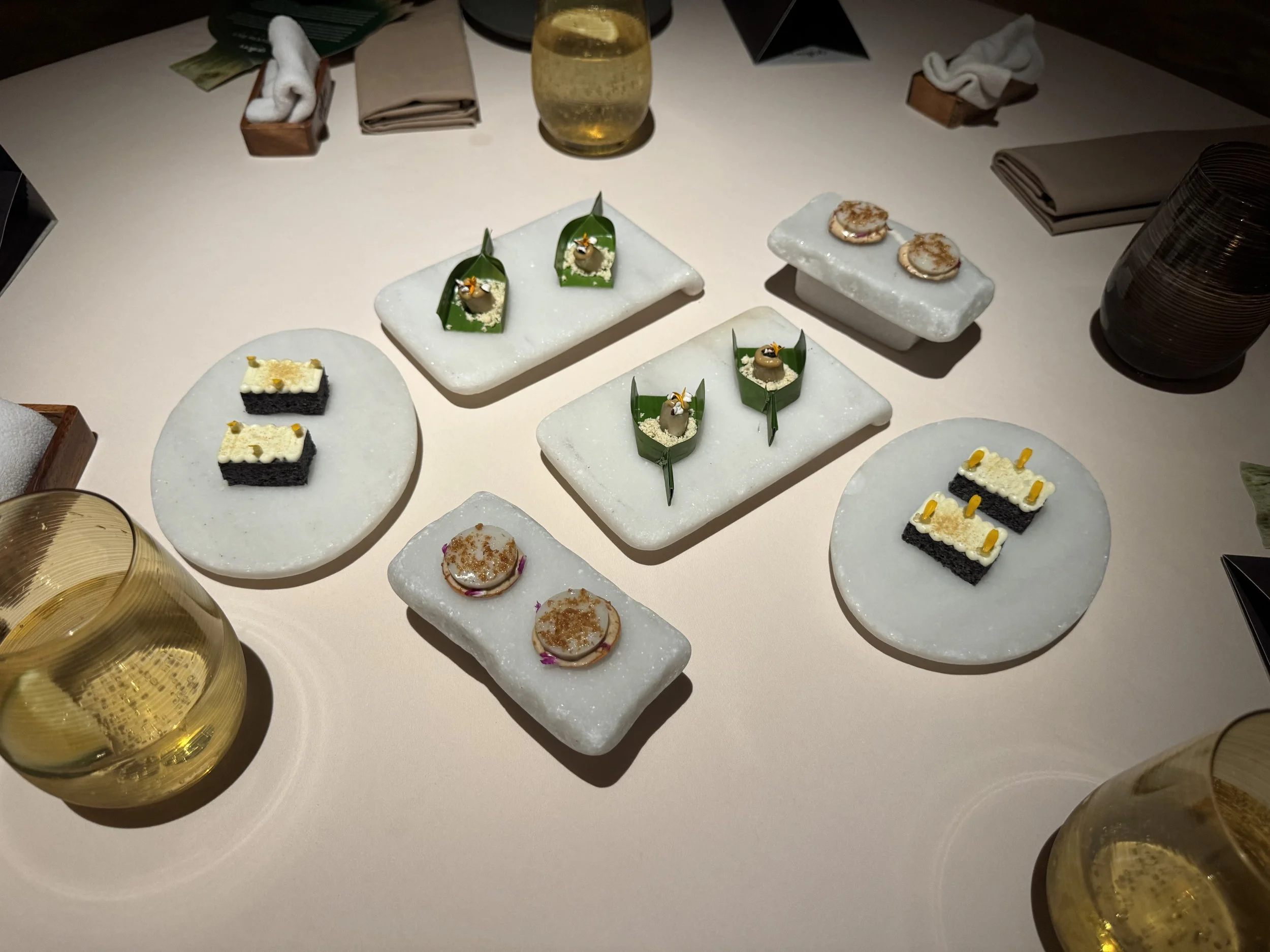 3 different types of rice cakes on white stone plates in pairs