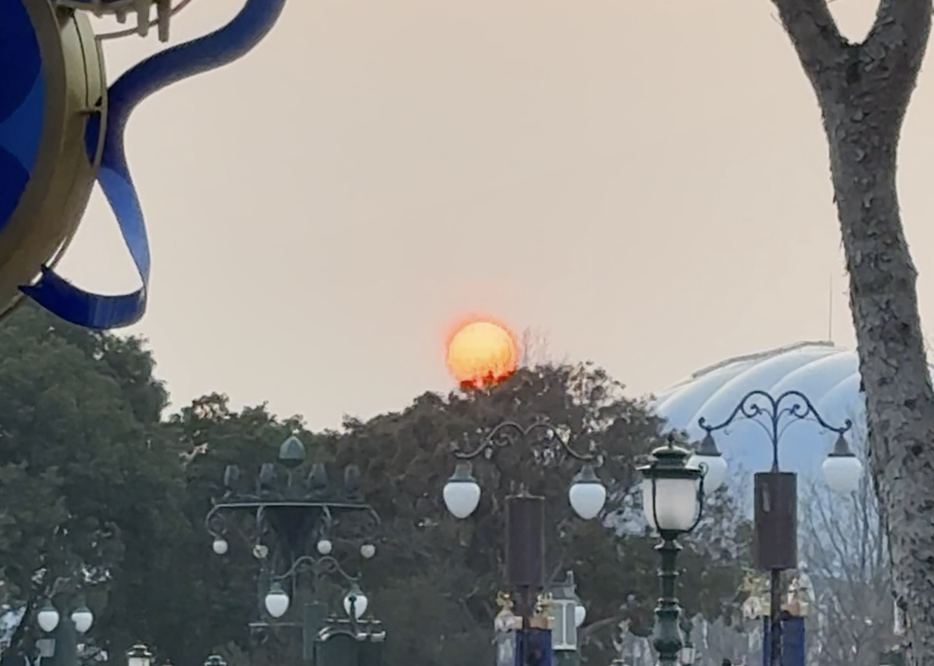Yellow/reddish sun at sunset at Shanghai Disneyland