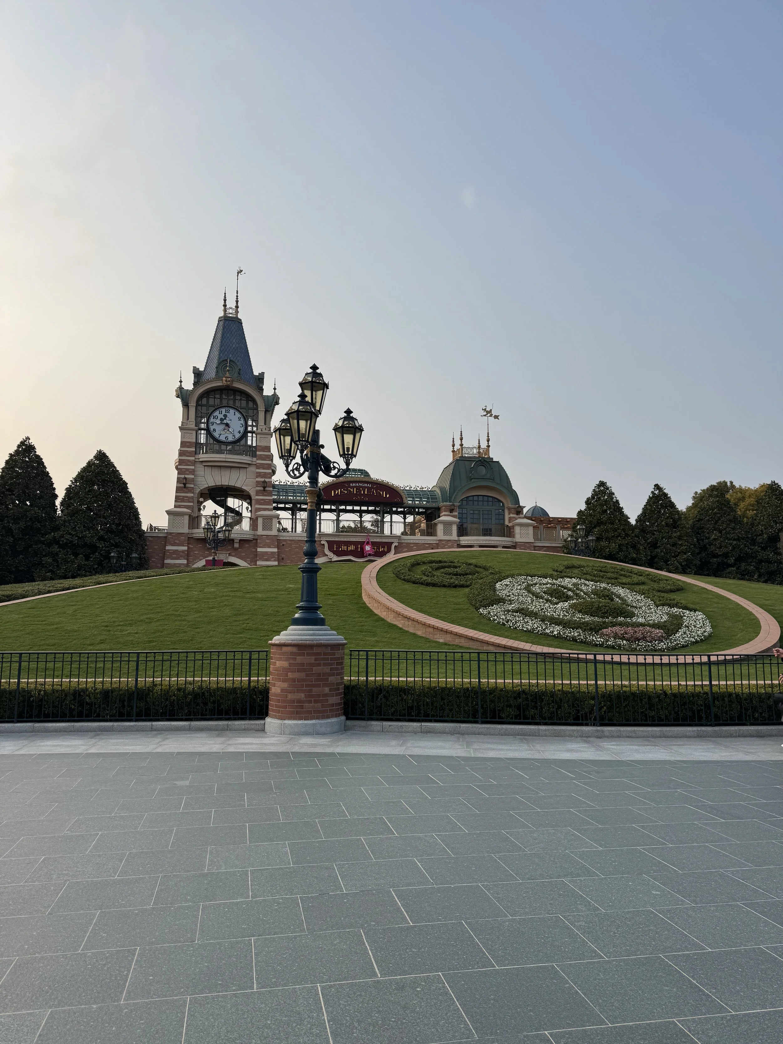 Shanghai Disneyland main entrance with Mickey lawn and Mickey clocktower