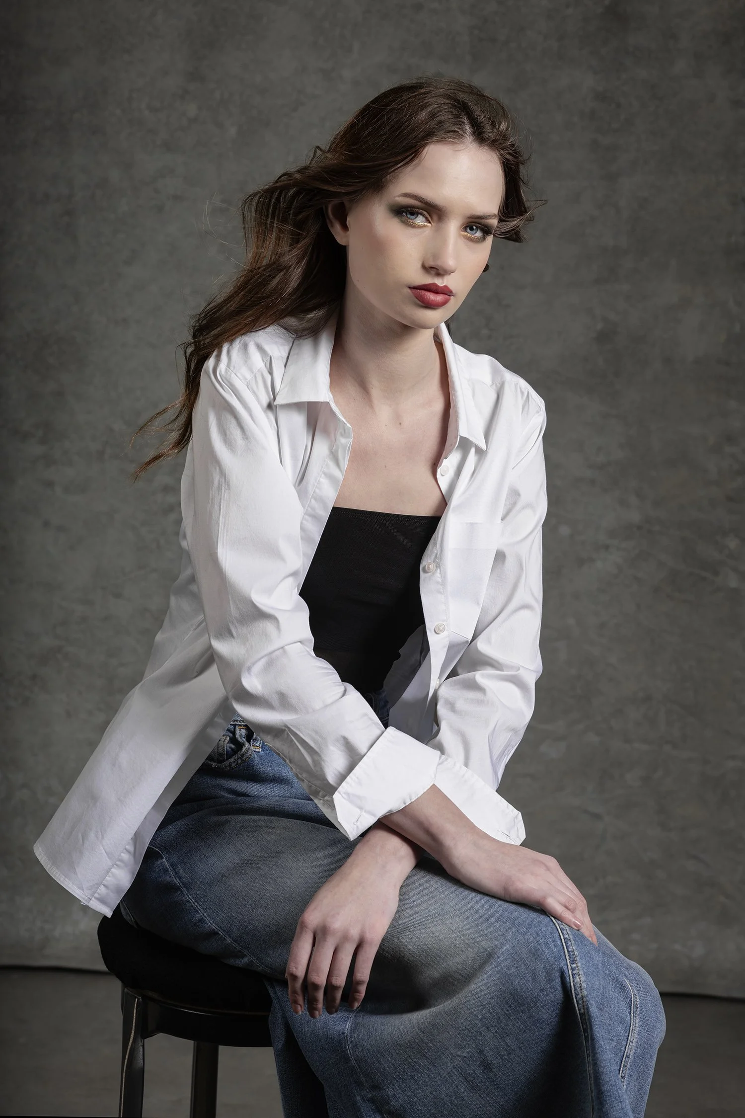 Headshot portrait of woman wearing white cotton button up shirt and denim skirt in studio photographed in Seattle Los Angeles and New York