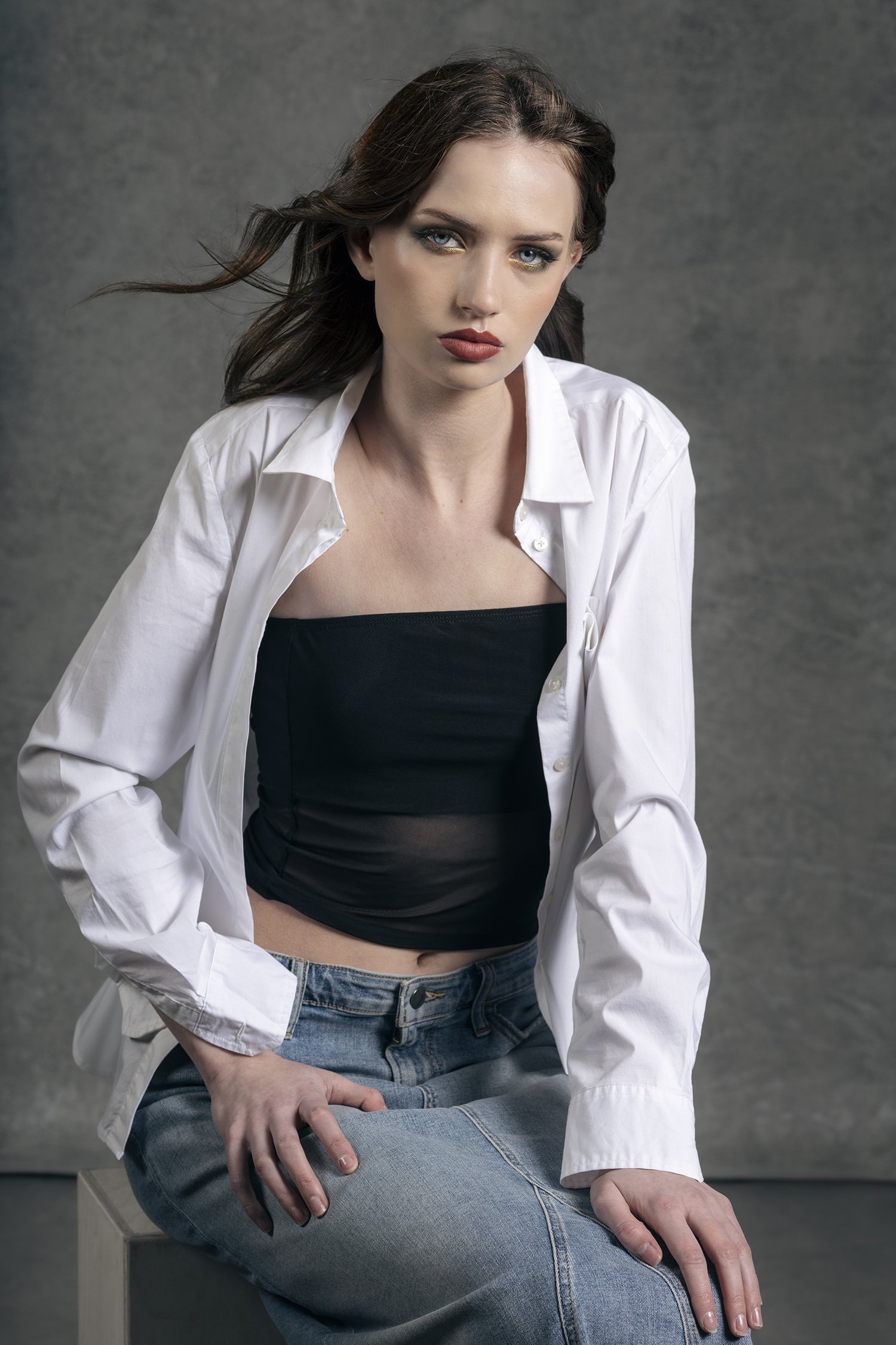 Portrait of woman wearing white button up cotton shirt in denim skirt photographed in Seattle.  High school senior portraits