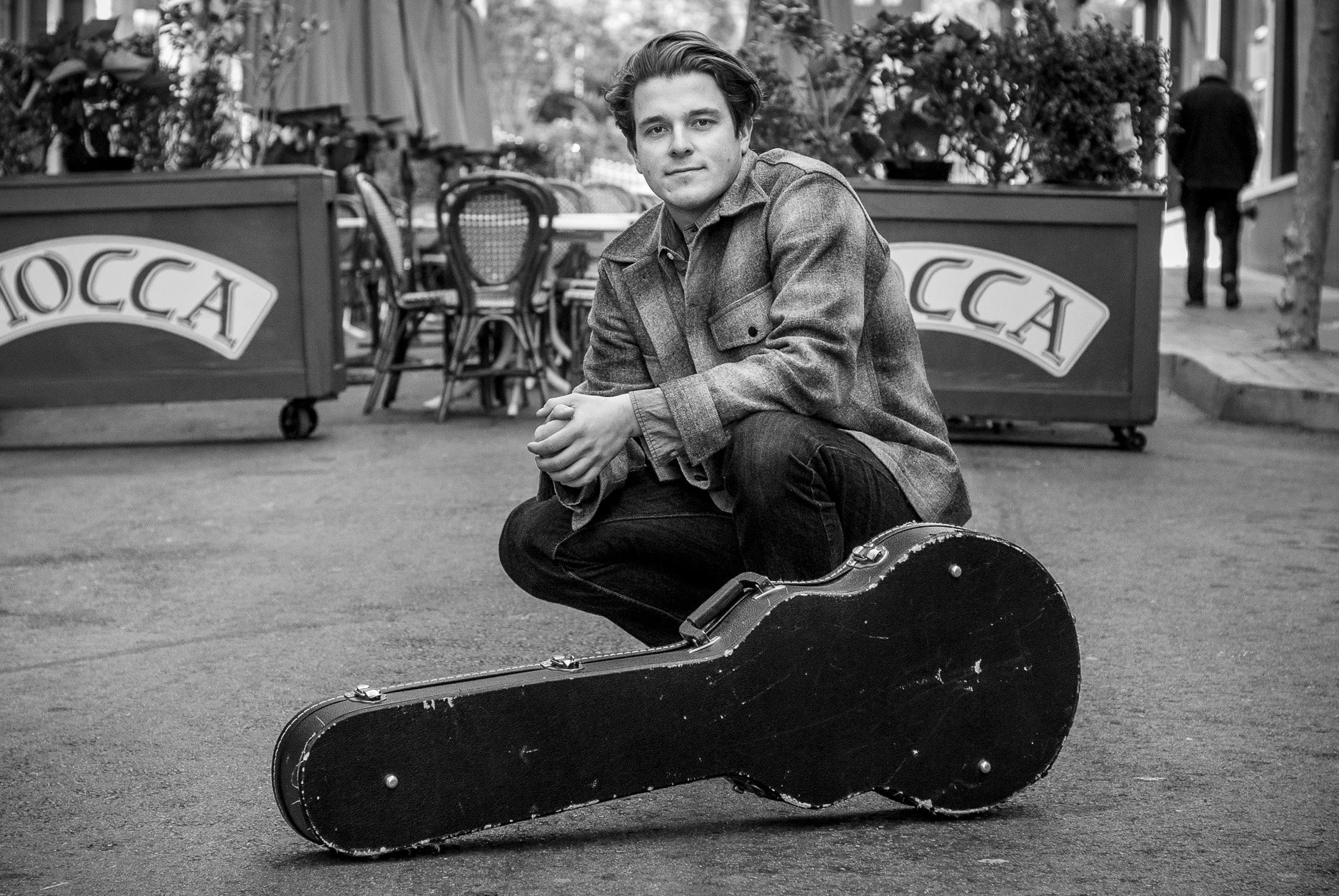 Male musician Sam Johnson photographed in San Francisco alley way in black and white with guitar.  Editorial portrait photographer